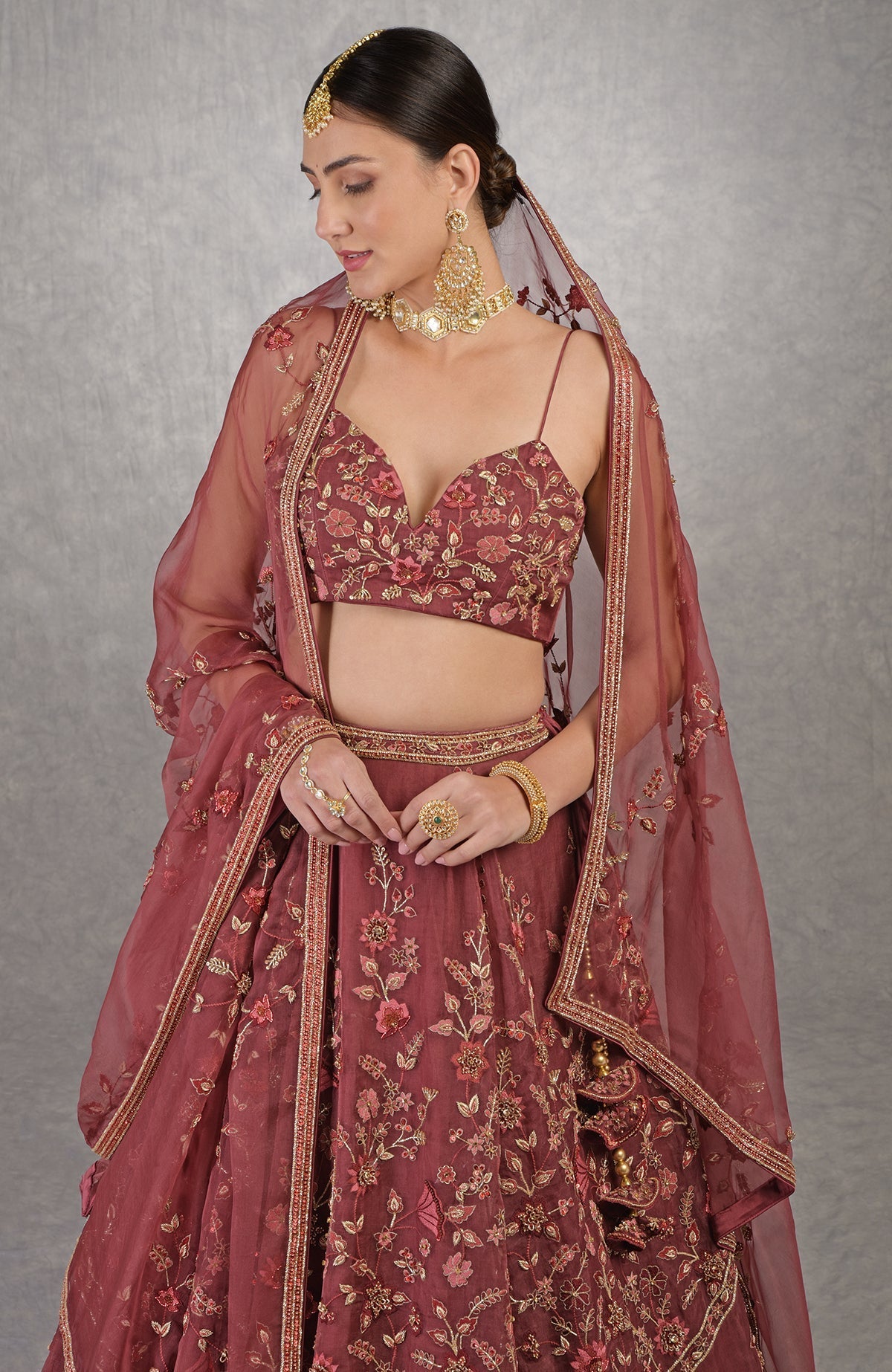 Burgundy wine lehenga set with floral embroidery, crystal highlights, and noodle strap blouse.