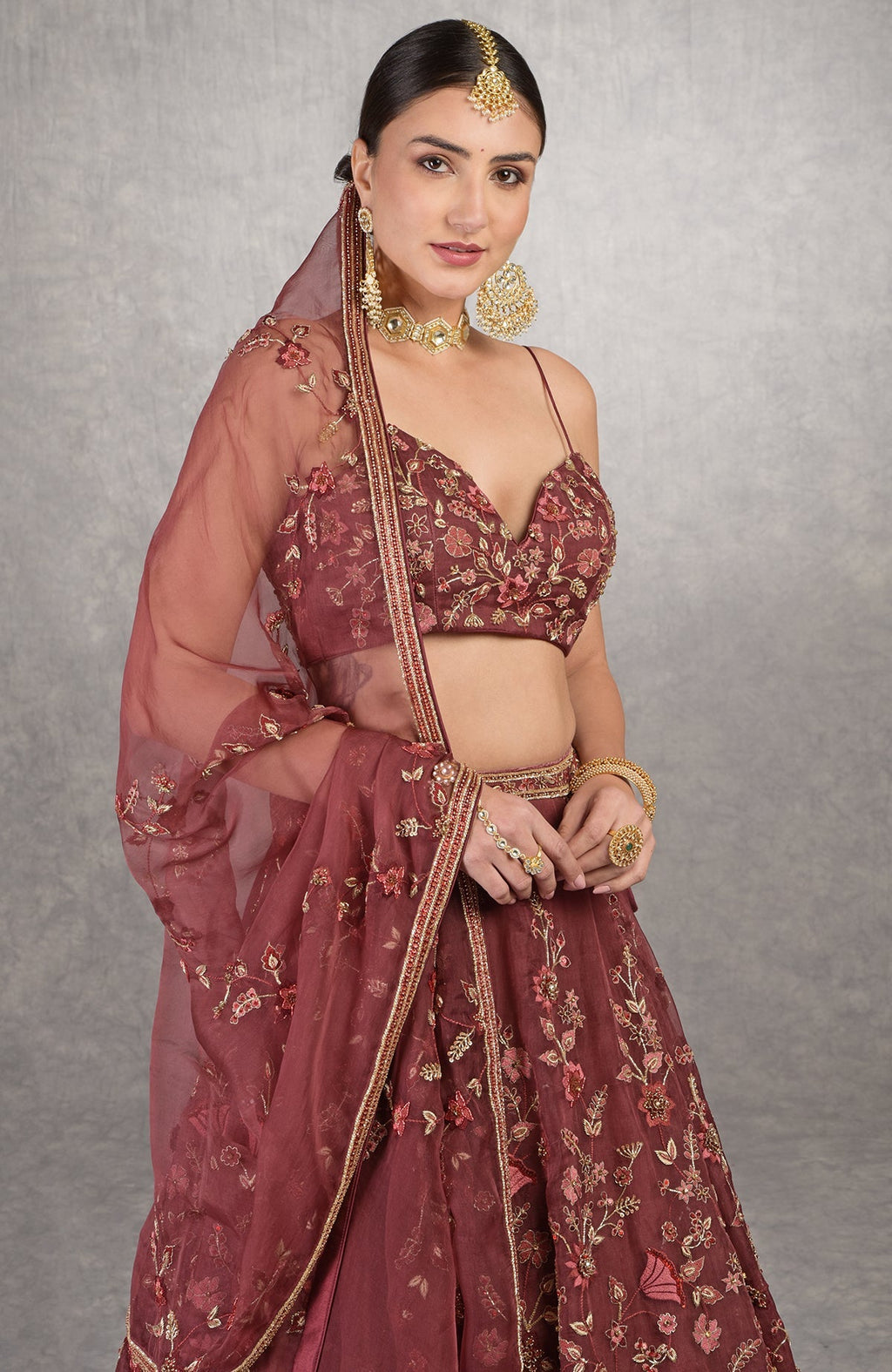 Burgundy wine lehenga set with floral embroidery, crystal highlights, and noodle strap blouse.