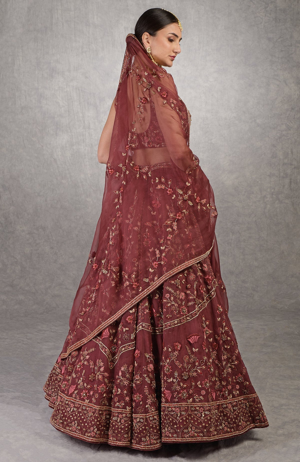 Burgundy wine lehenga set with floral embroidery, crystal highlights, and a sweetheart blouse.