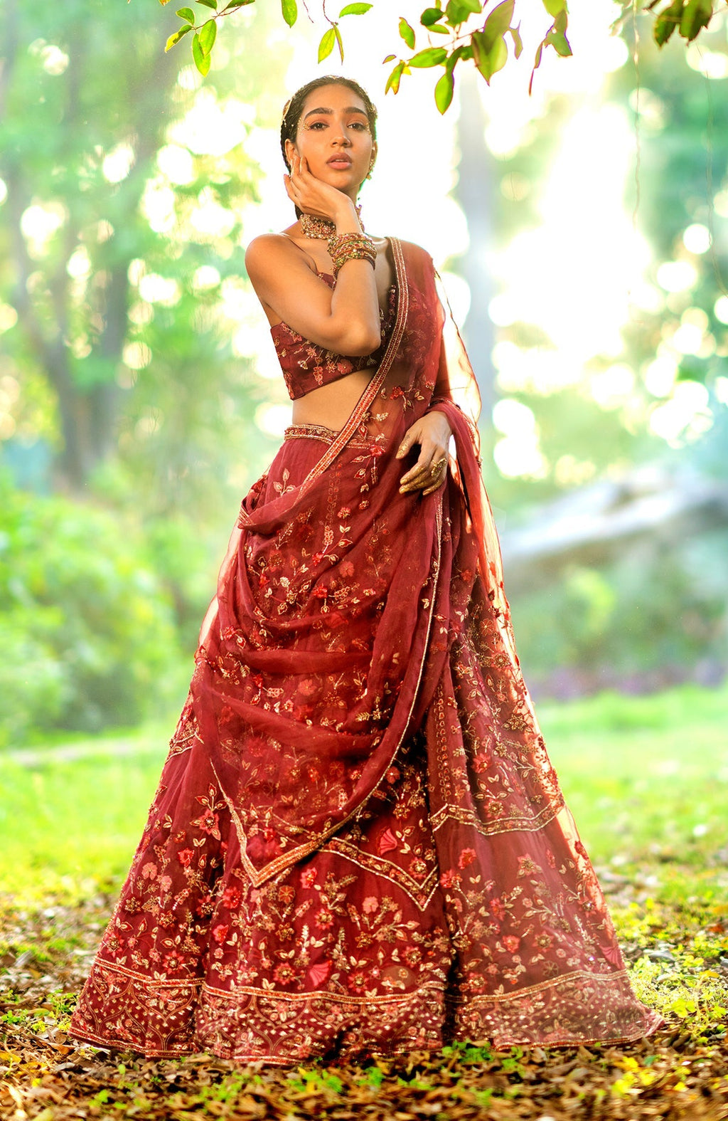 Burgundy wine lehenga set with floral embroidery, crystal accents, and a scoop neck blouse.