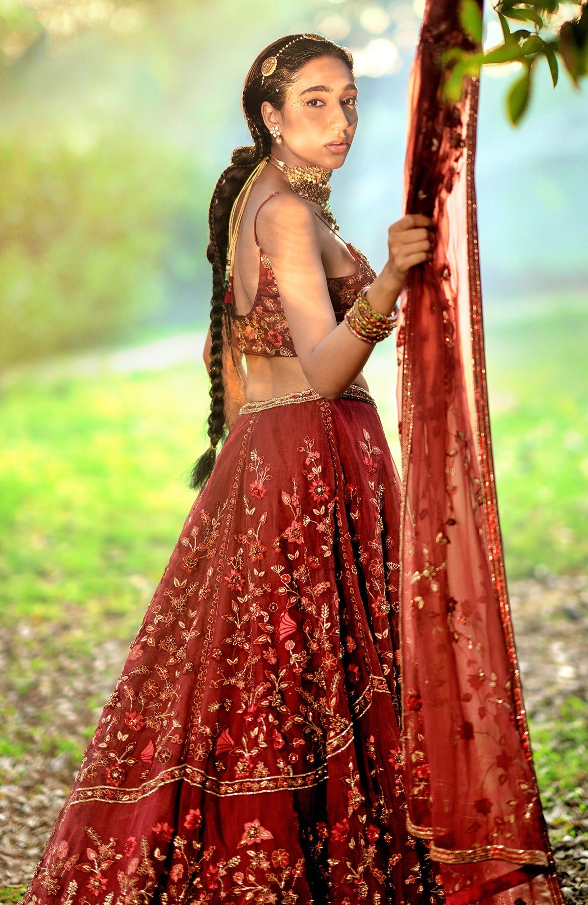 Burgundy wine lehenga set with floral embroidery, crystal accents, and a scoop neck blouse.