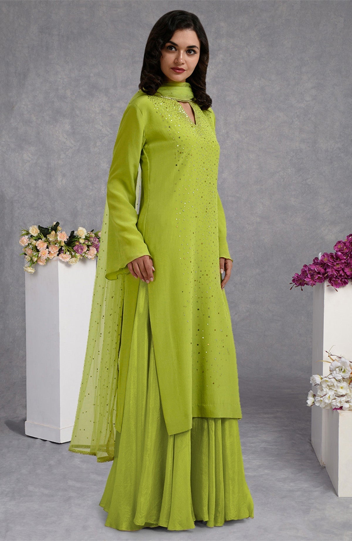 Lime punch skirt set with hand-embroidered gold and silver sequins and sheer bell sleeves.