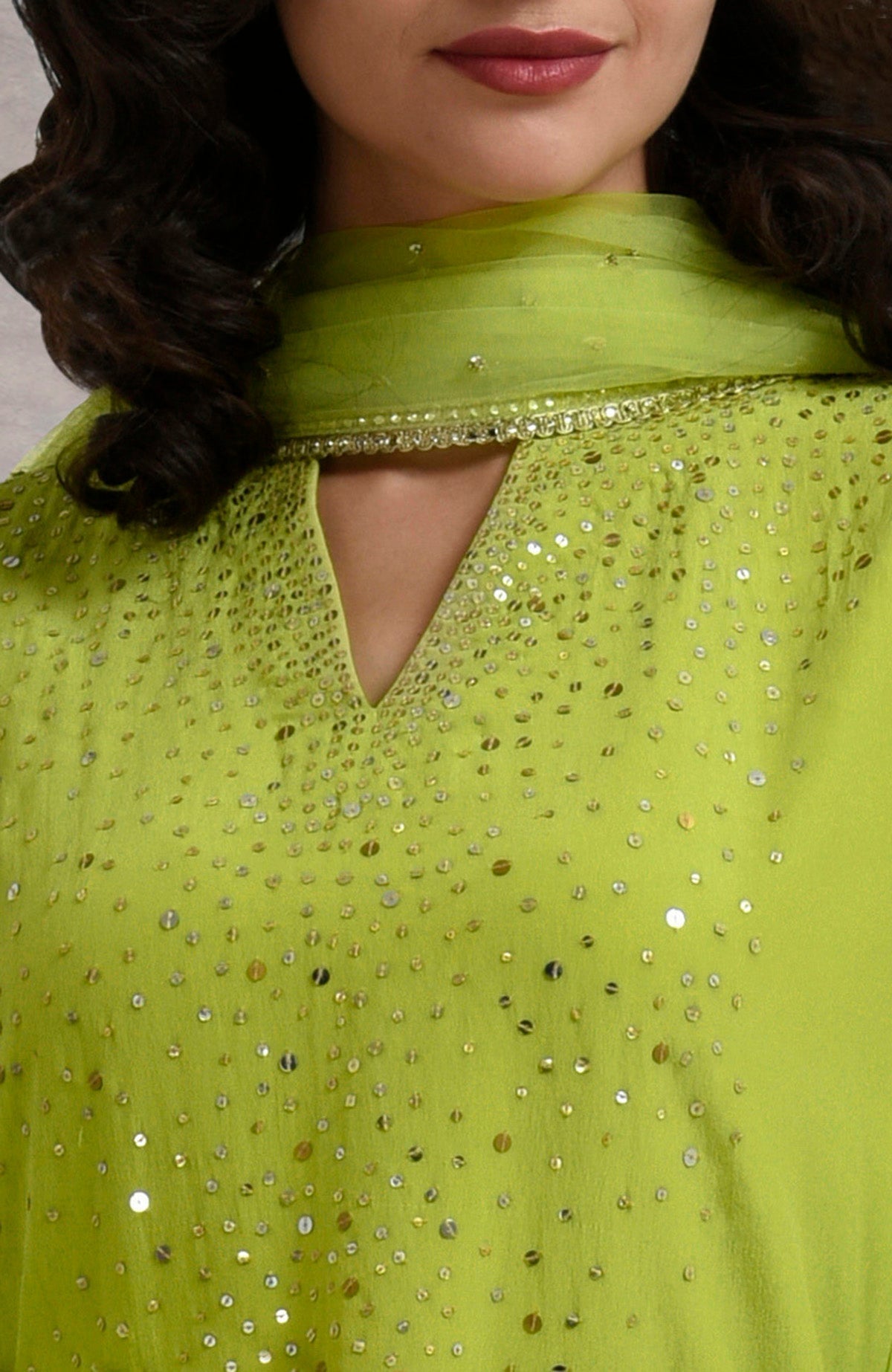 Lime punch skirt set with hand-embroidered gold and silver sequins and sheer bell sleeves.