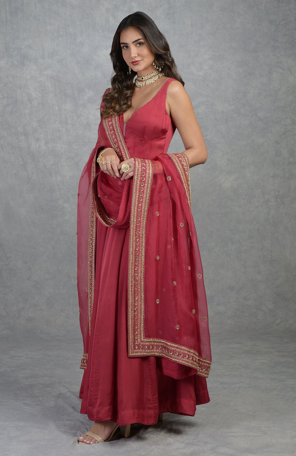 Garnet red Anarkali set with hand-embroidered gold zardozi and floral motifs on organza fabric