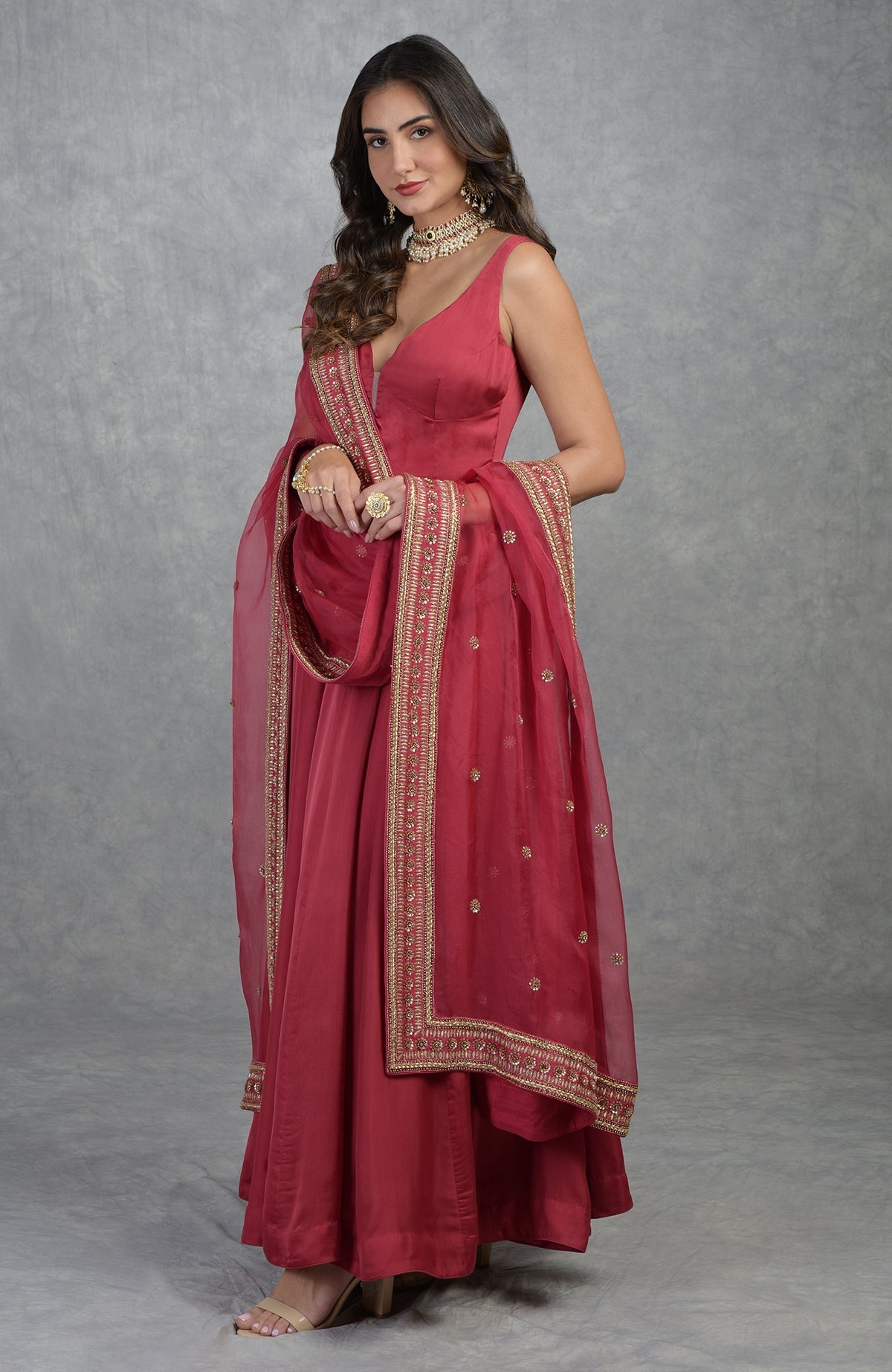 Garnet red Anarkali set with hand-embroidered gold zardozi and floral motifs on organza fabric