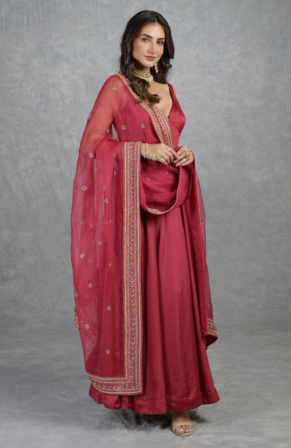 Garnet red Anarkali set with hand-embroidered zardozi and floral motifs on organza fabric.