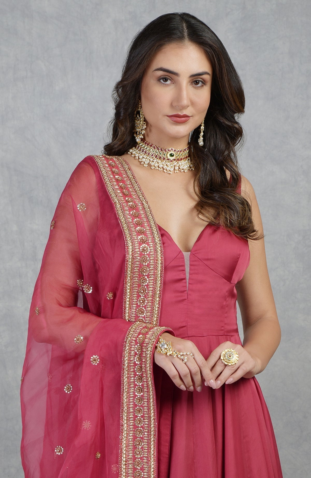 Garnet red Anarkali set with hand-embroidered zardozi and floral motifs on organza fabric.
