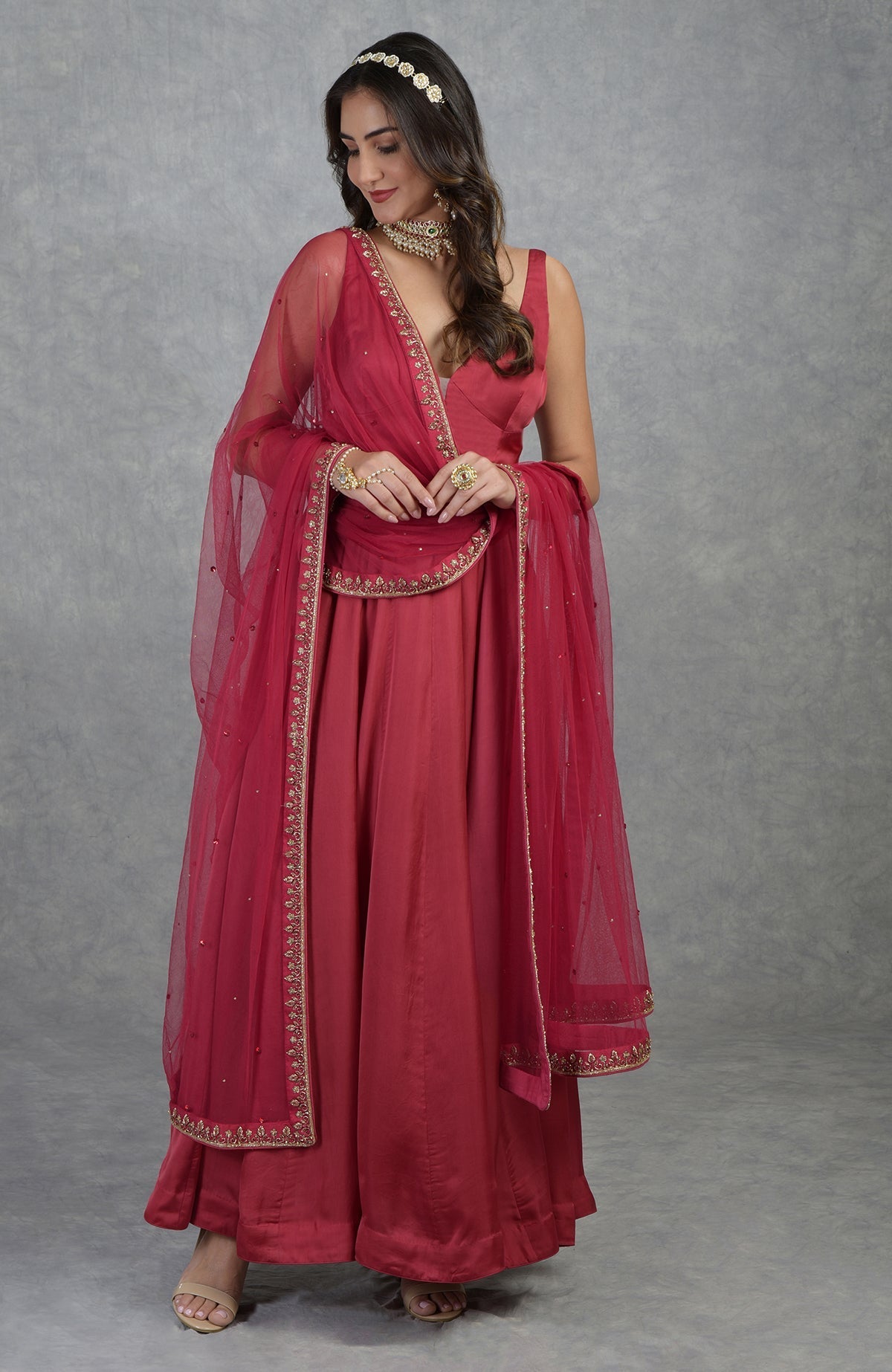 Garnet red Anarkali set with hand-embroidered zardozi floral motifs and matching tulle dupatta.