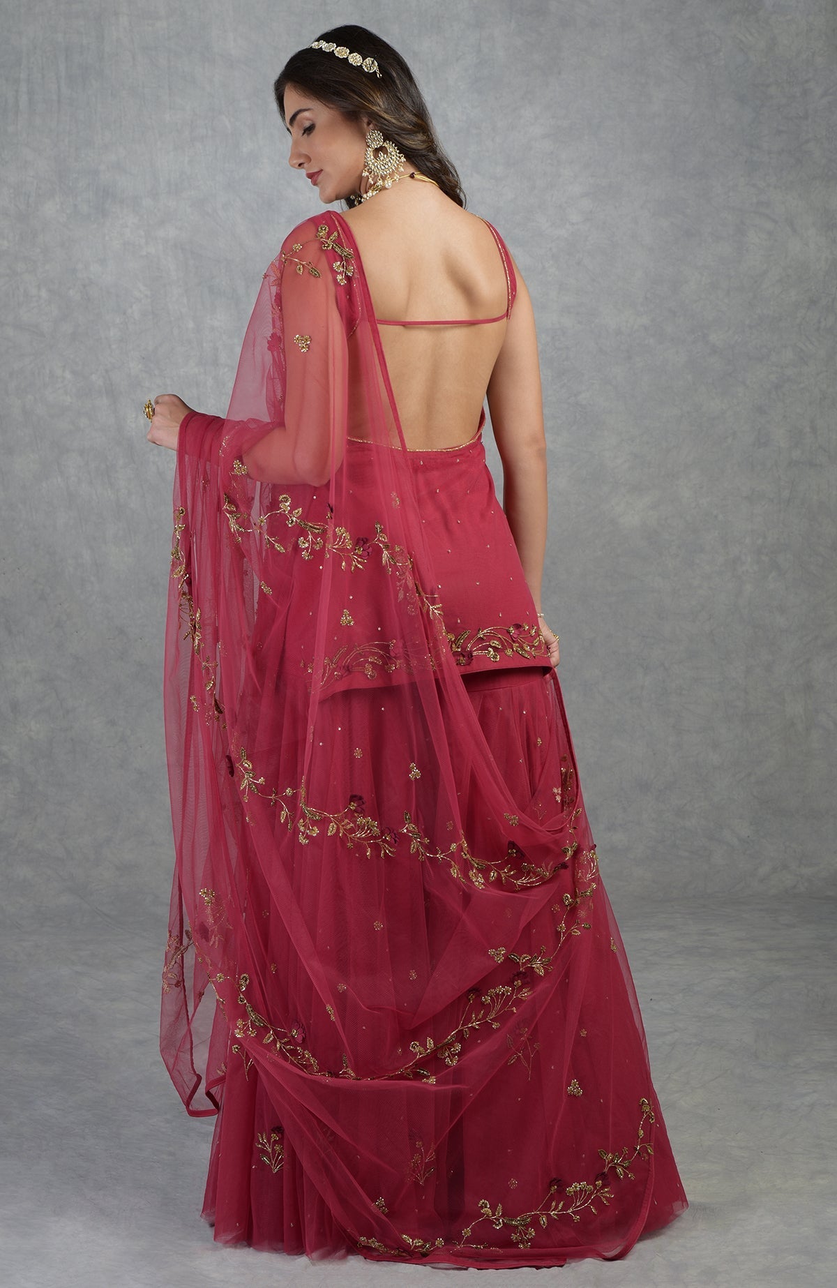 Red sharara set with 3D floral and gold hand embroidery on tulle, including dupatta and kurta.