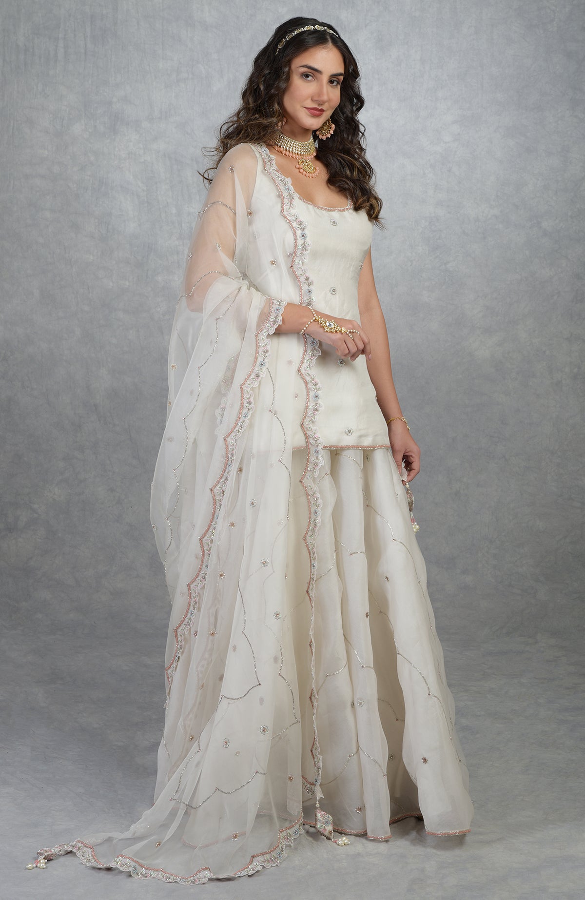 Off white silk organza sharara set with hand-embroidered floral beads, sequins, and dupatta.