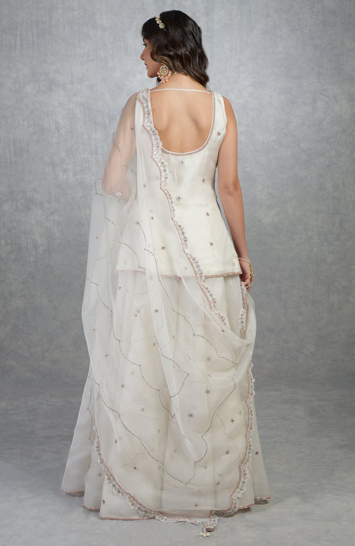 Off white silk organza sharara set with hand-embroidered floral beads, sequins, and crystal details