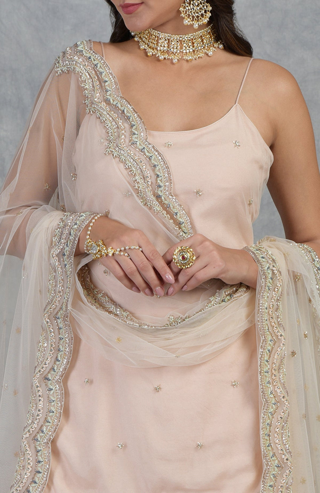 Champagne pink sharara set with hand-embroidered beads, sequins, crystals, and floral motifs.