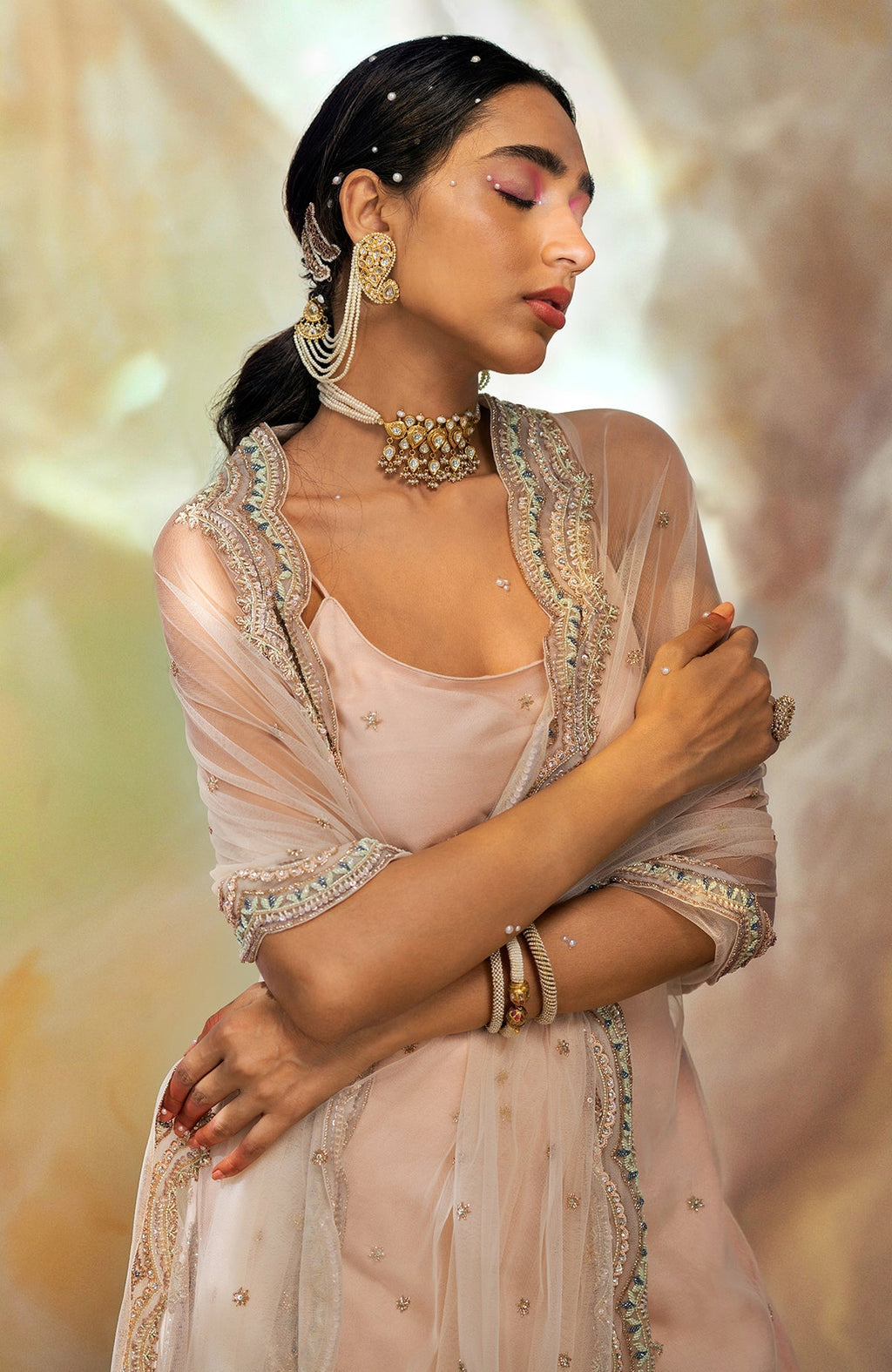 Champagne pink sharara set with hand-embroidered beads, sequins, crystals, and floral motifs.