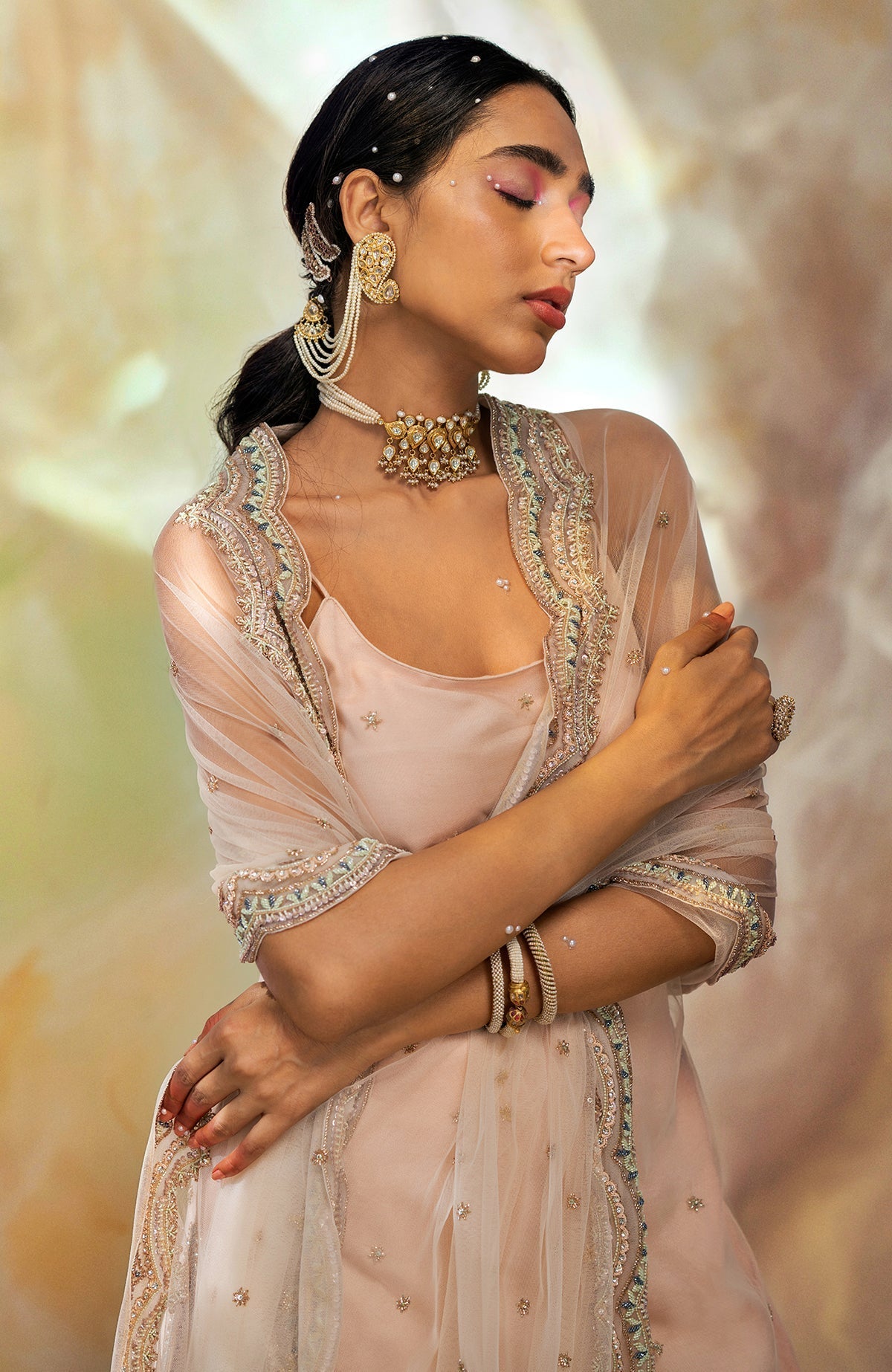 Champagne pink sharara set with hand-embroidered beads, sequins, crystals, and floral motifs.
