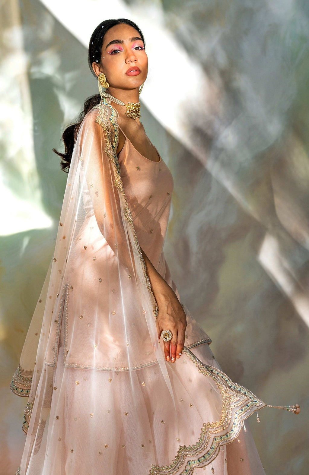 Champagne pink sharara set with hand-embroidered beads, sequins, crystals, and floral motifs.