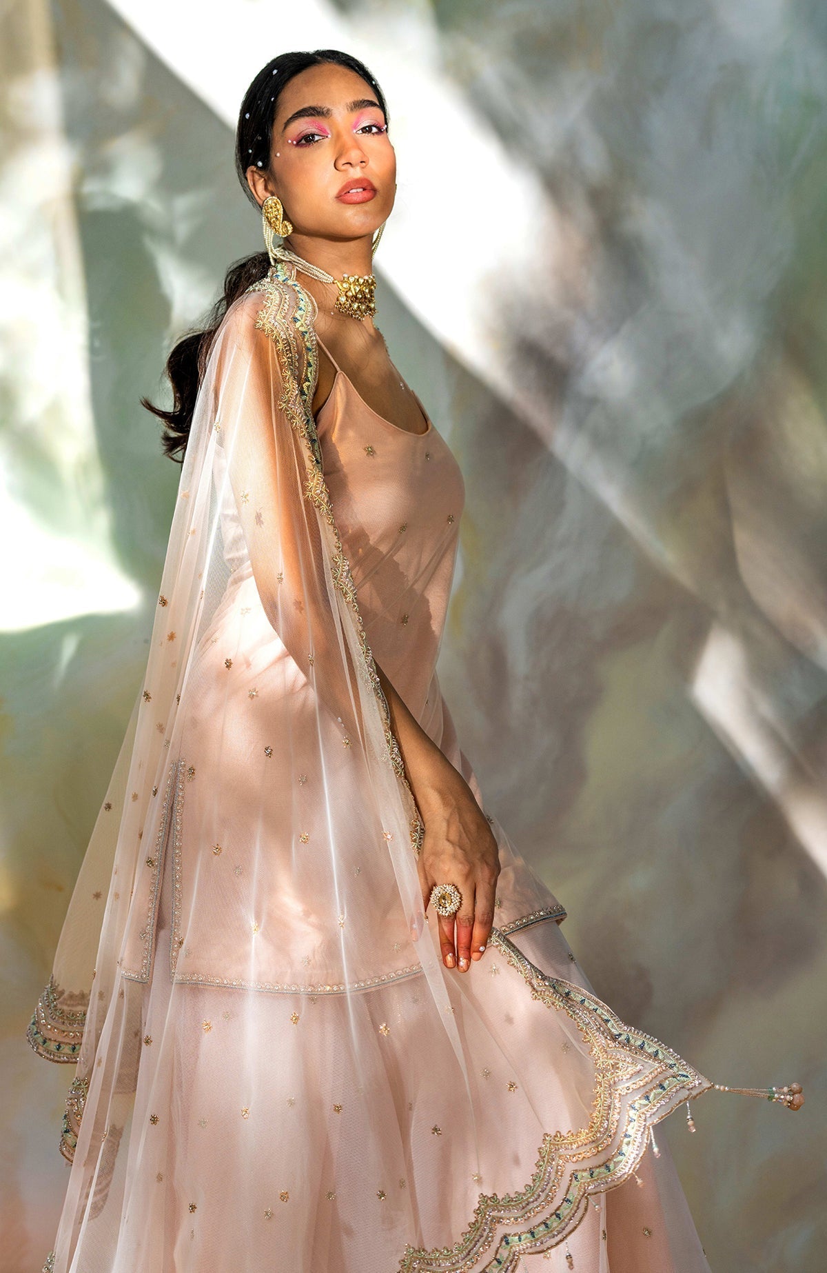 Champagne pink sharara set with hand-embroidered beads, sequins, crystals, and floral motifs.