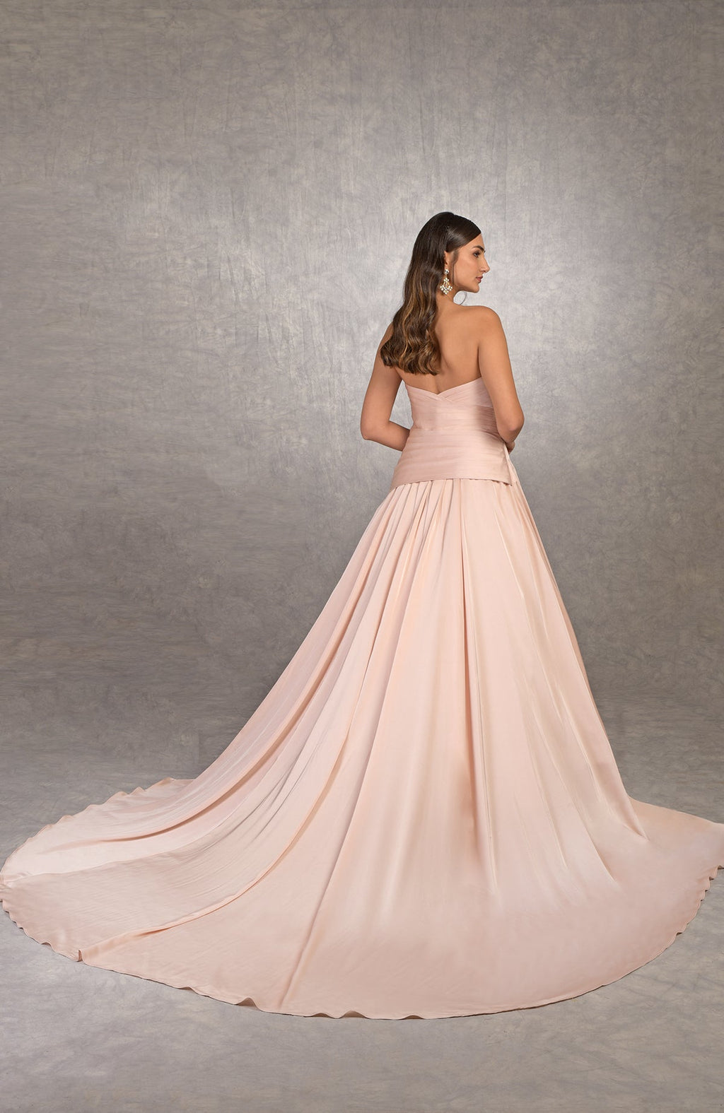 Strapless pleated satin ballgown with draped bodice and circular train in classic silhouette