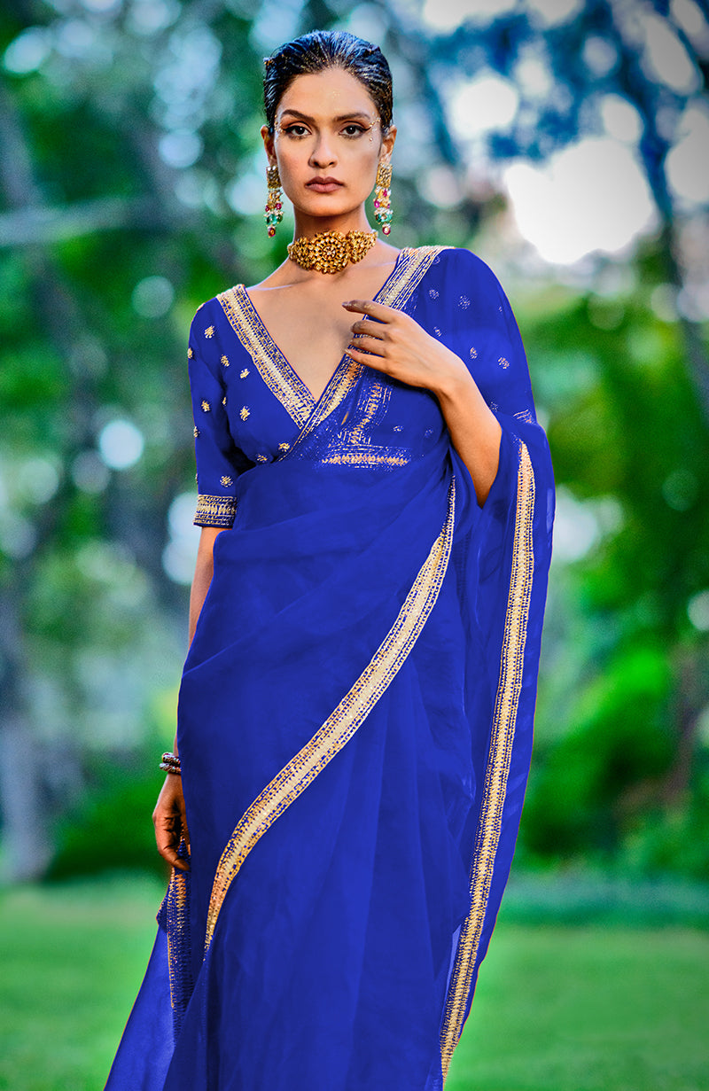 Royal blue organza silk saree with crystal, sequin, and zari embroidery.