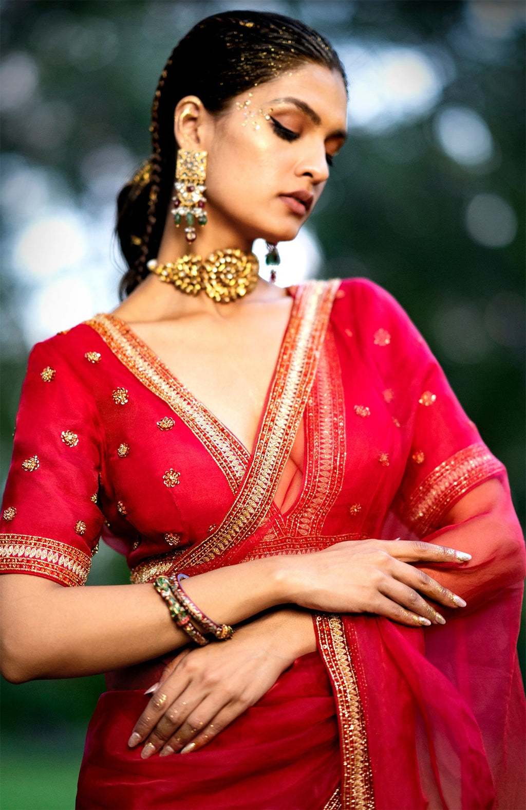 Red organza silk saree with gold and red crystal bead and zari embroidery and matching blouse