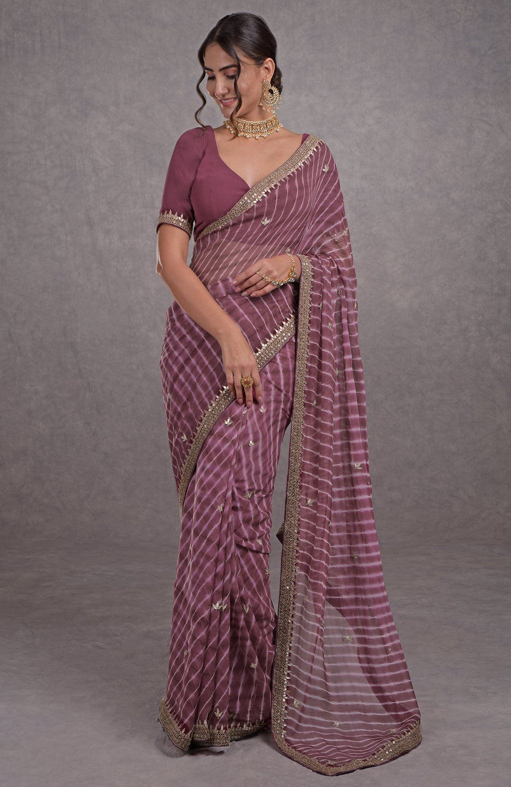 Burgundy chiffon saree with leheriya pattern and rose gold marori-gota patti hand embroidery.