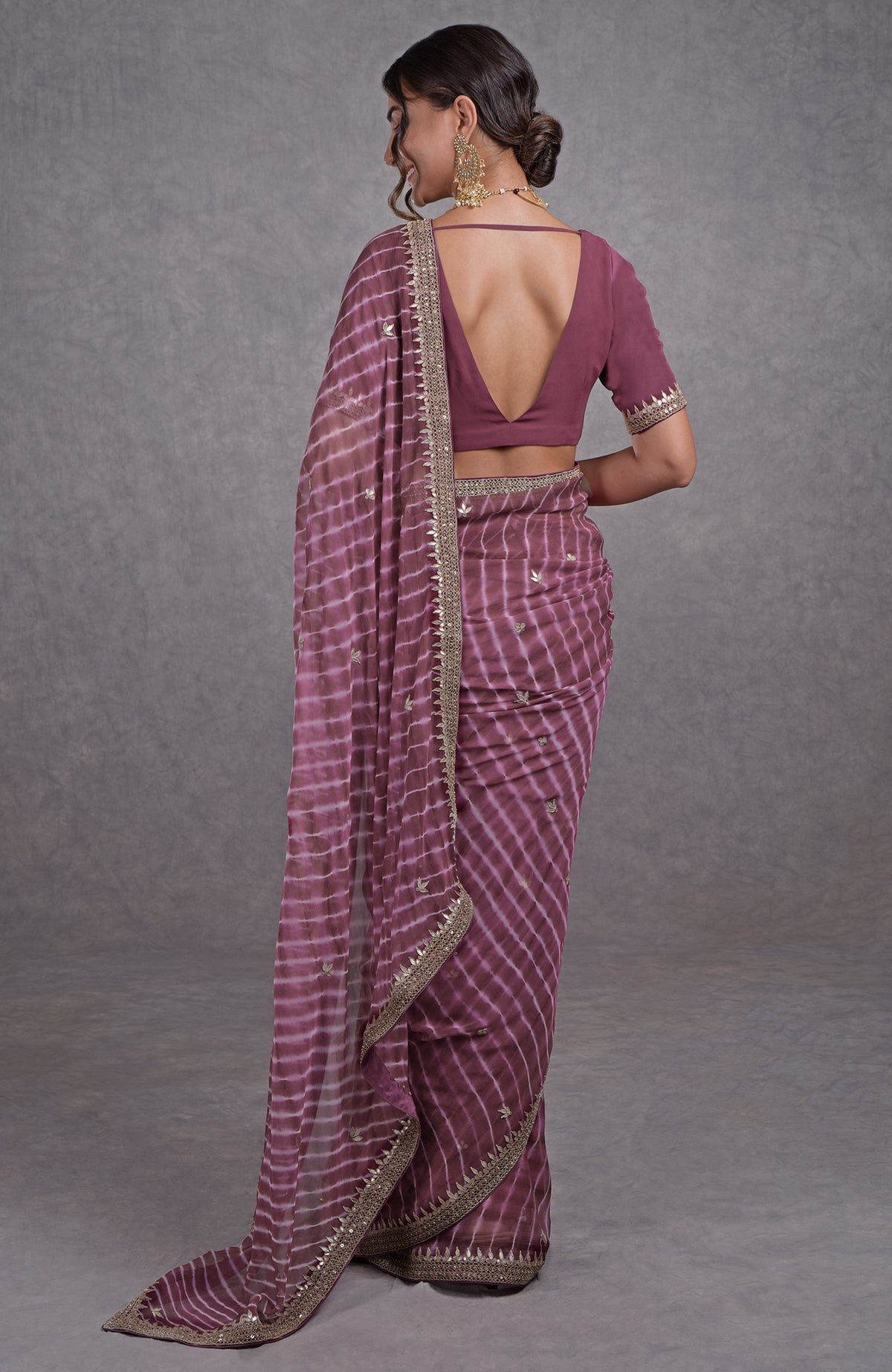 Burgundy chiffon saree with leheriya pattern and rose gold marori-gota patti hand embroidery.