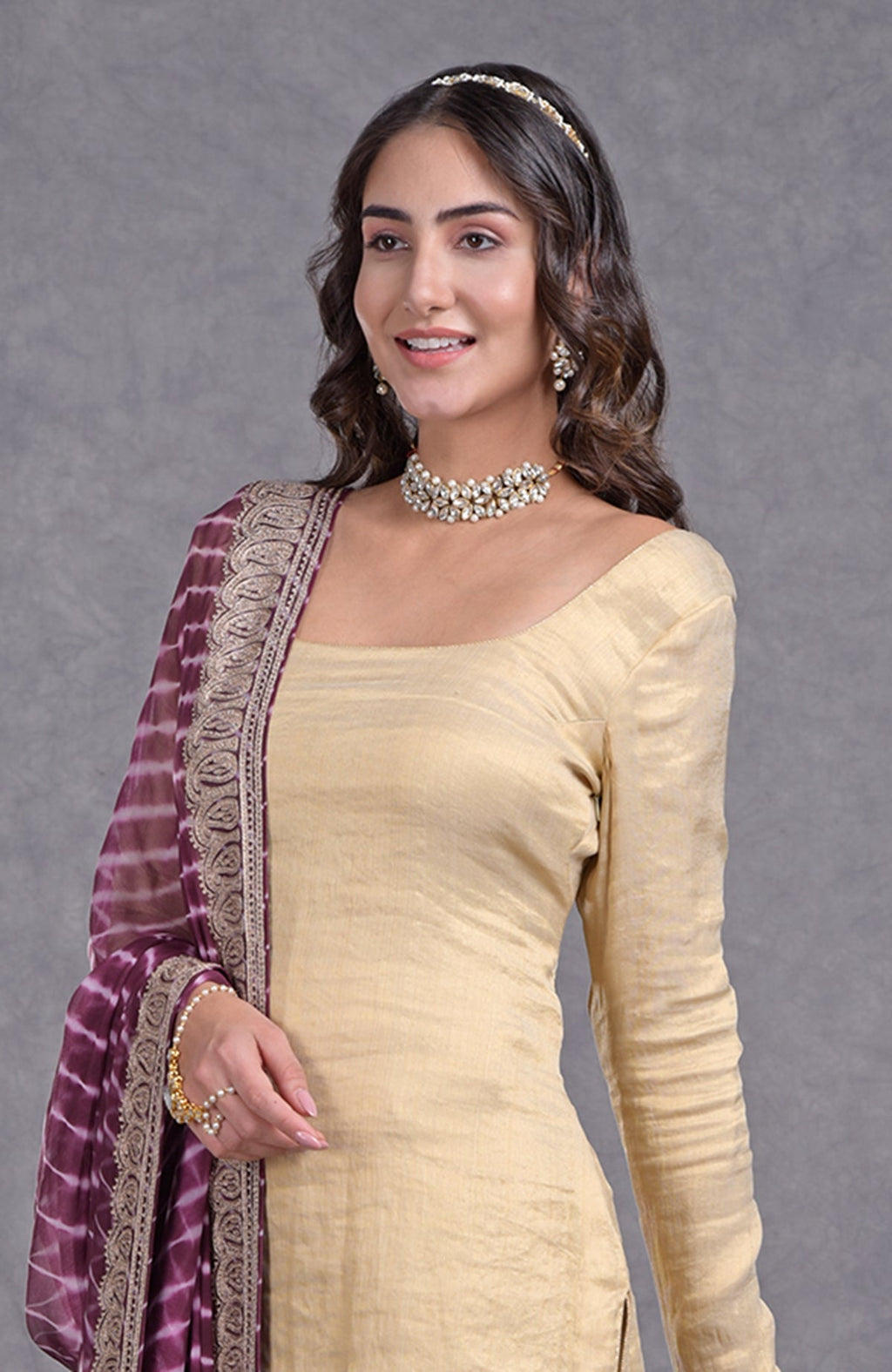 Burgundy purple chiffon dupatta with white leheriya and rose gold tilla border paired with gold tissue sharara suit.