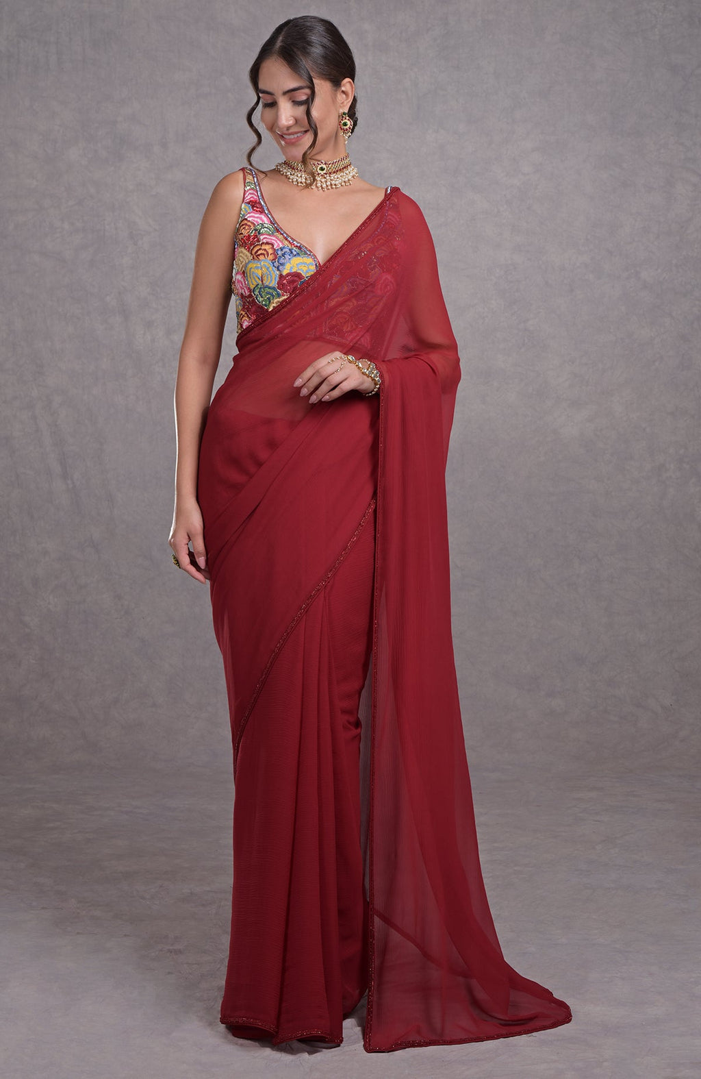 Red saree with multicolor resham, dabka, sequin, bead embroidery and floral motifs on blouse