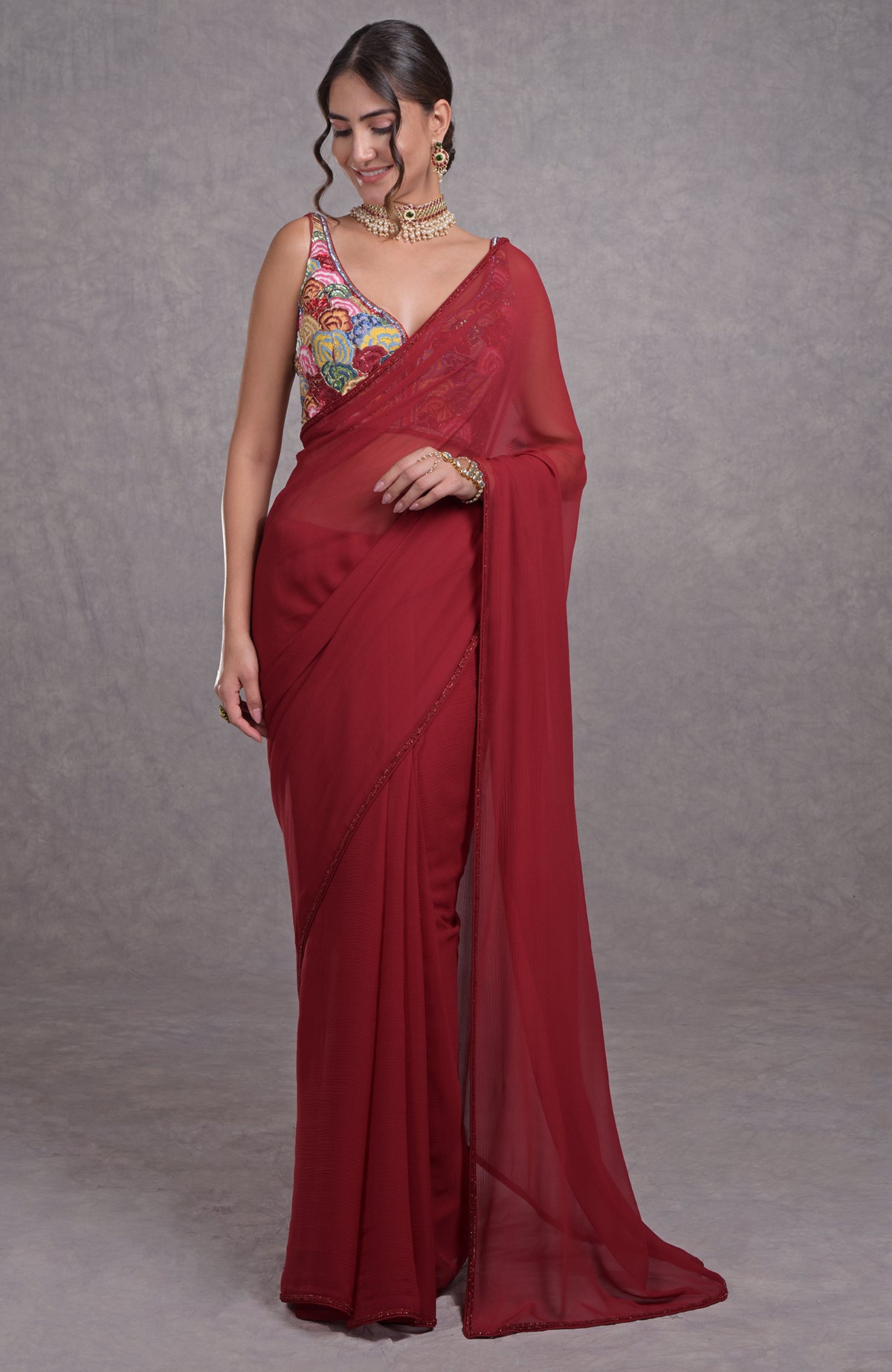 Red saree with multicolor resham, dabka, sequin, bead embroidery and floral motifs on blouse