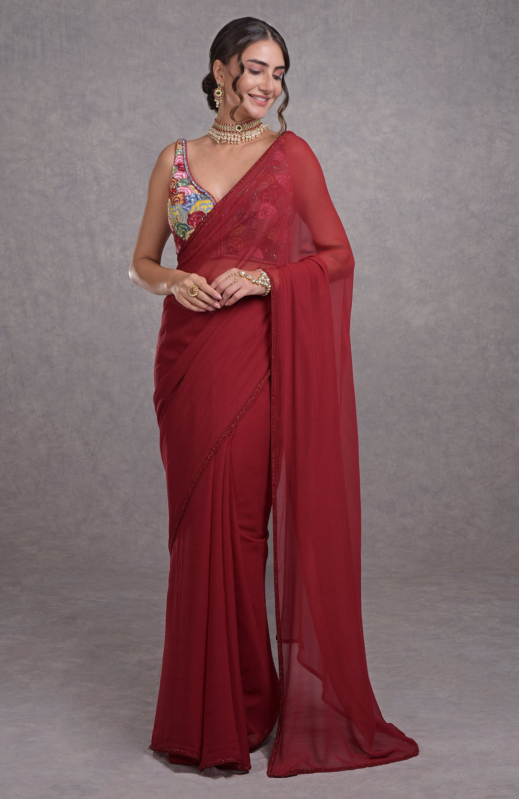 Red saree with multicolor floral resham, dabka, sequin, and bead embroidery and a sweetheart blouse.