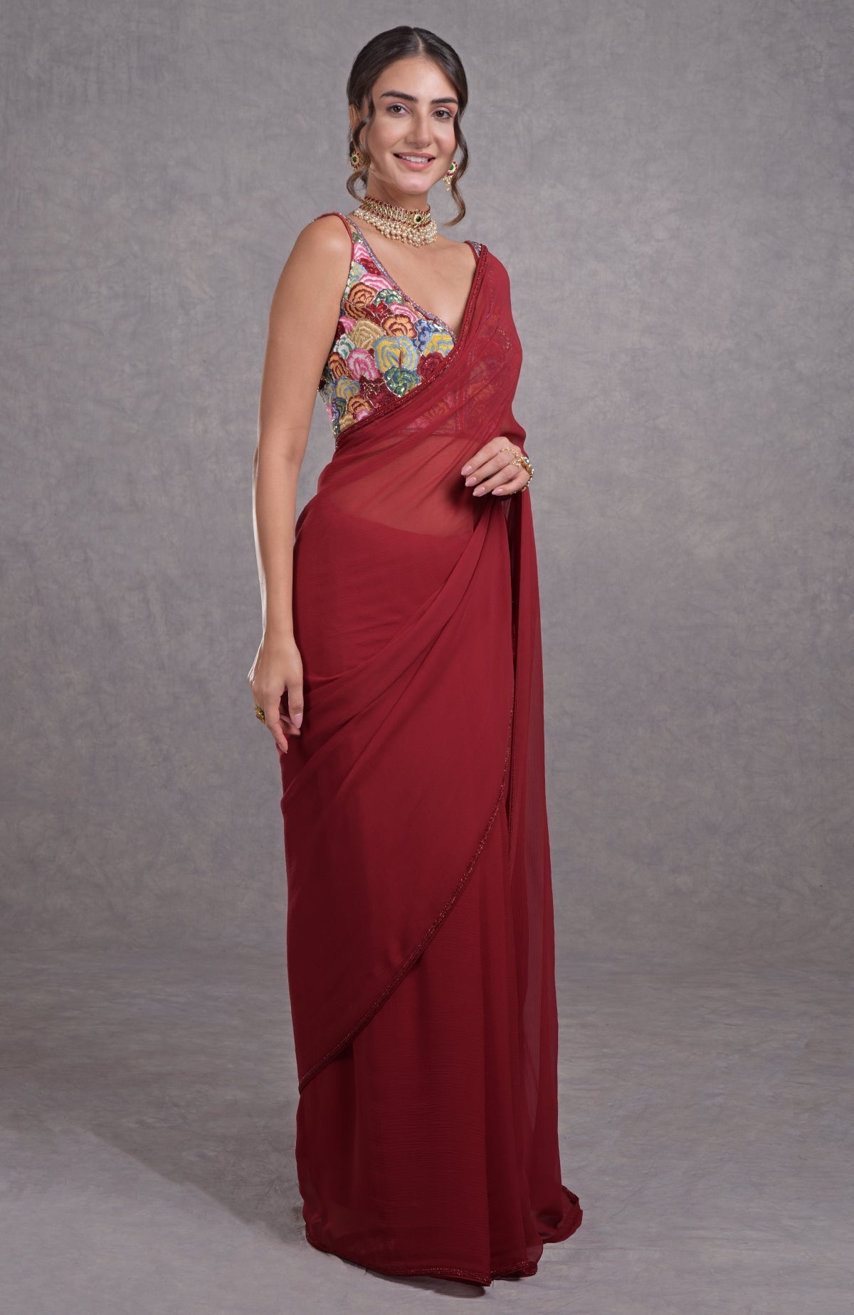 Red saree with multicolor floral resham, dabka, sequin, and bead hand embroidery.