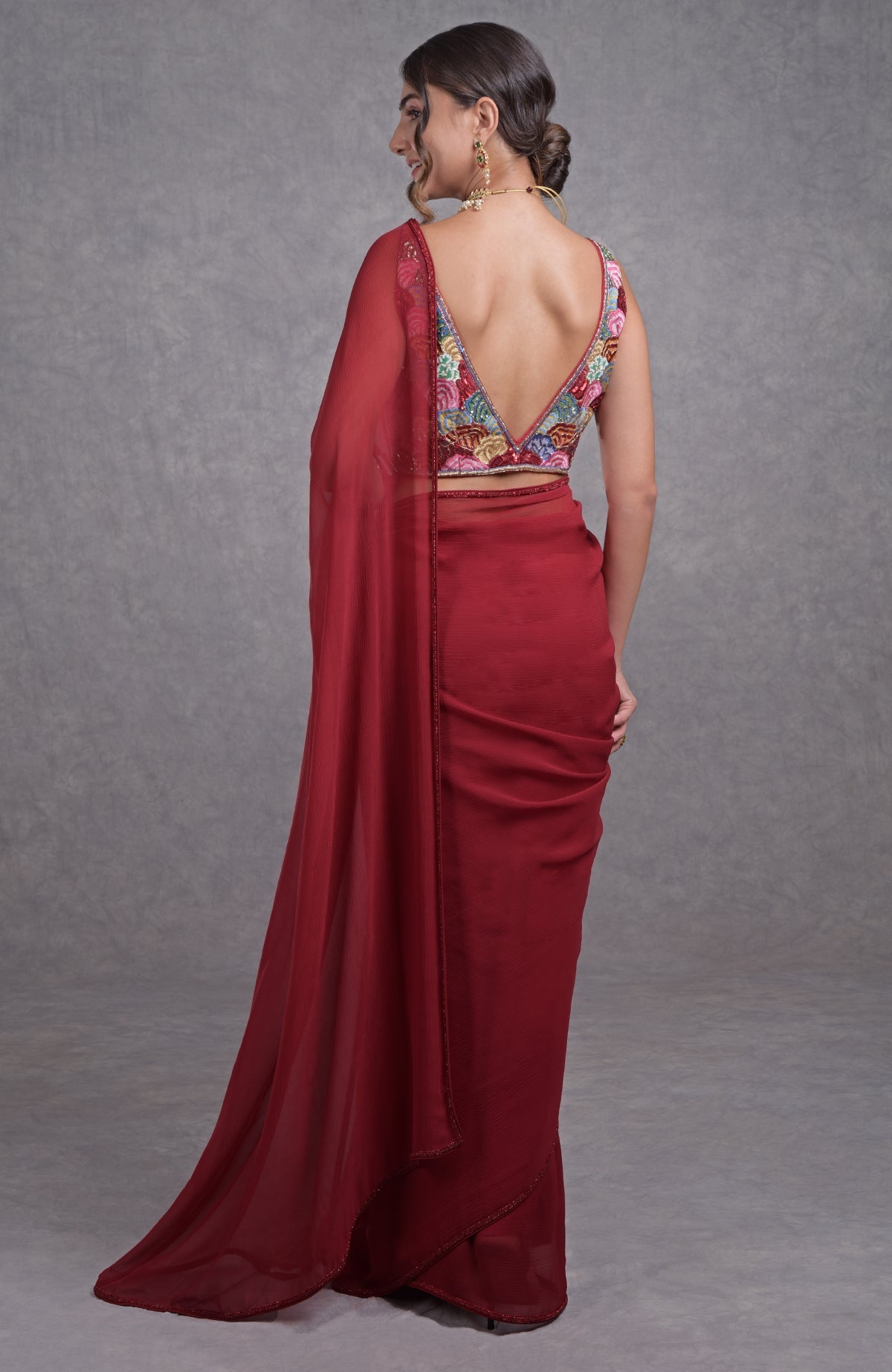 Red saree with multicolor floral resham, dabka, sequin, and bead hand embroidery details.