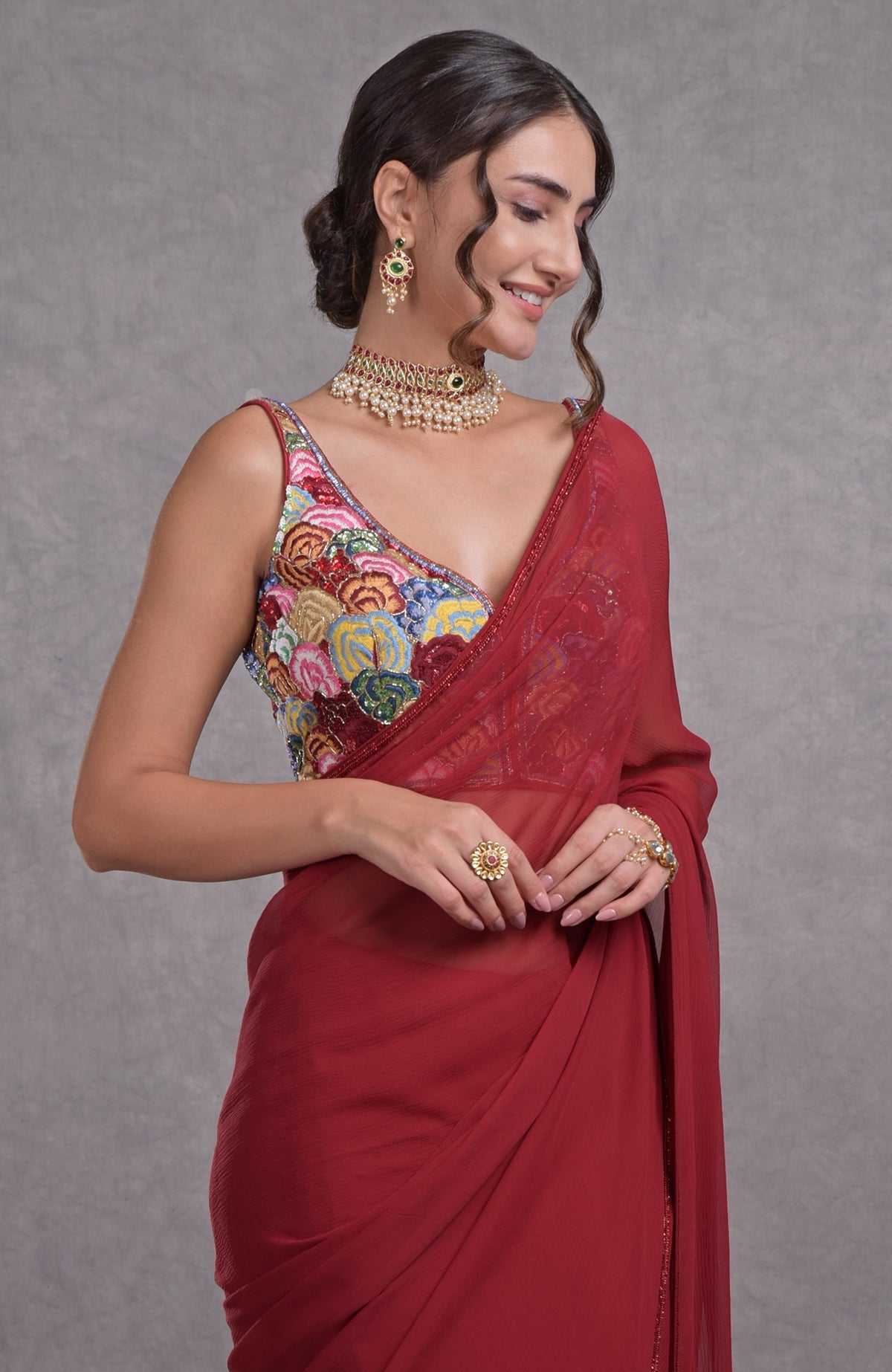 Red saree with multicolor resham dabka, sequin, bead embroidery and floral hand-embroidered blouse