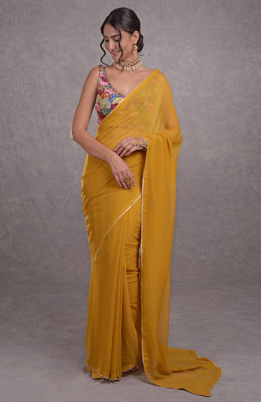Mustard yellow saree with multicolor resham, dabka, sequin, bead, and Kamdani embroidery.