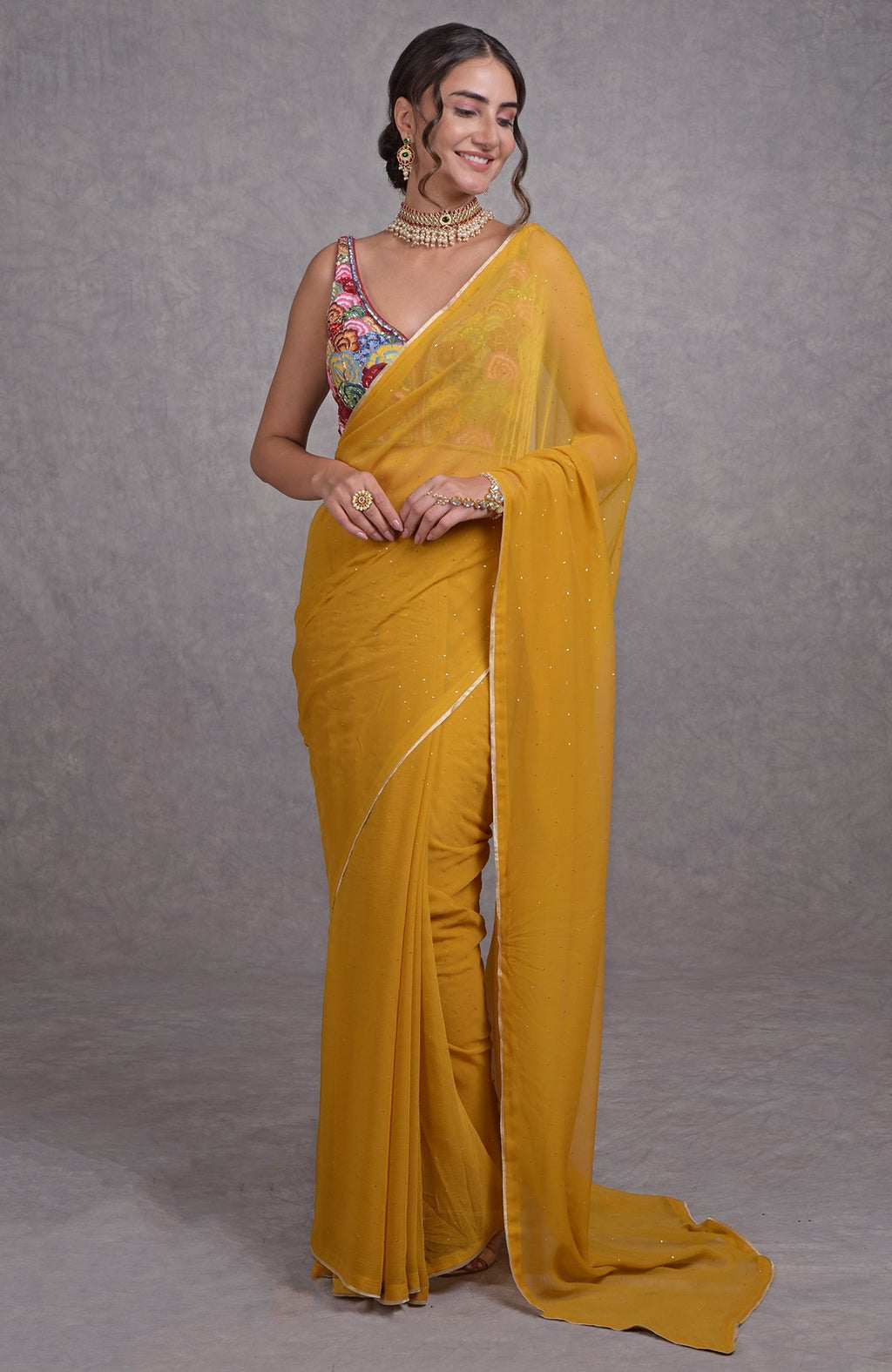 Mustard yellow saree with multicolor resham, dabka, sequin, bead, and Kamdani embroidery details.