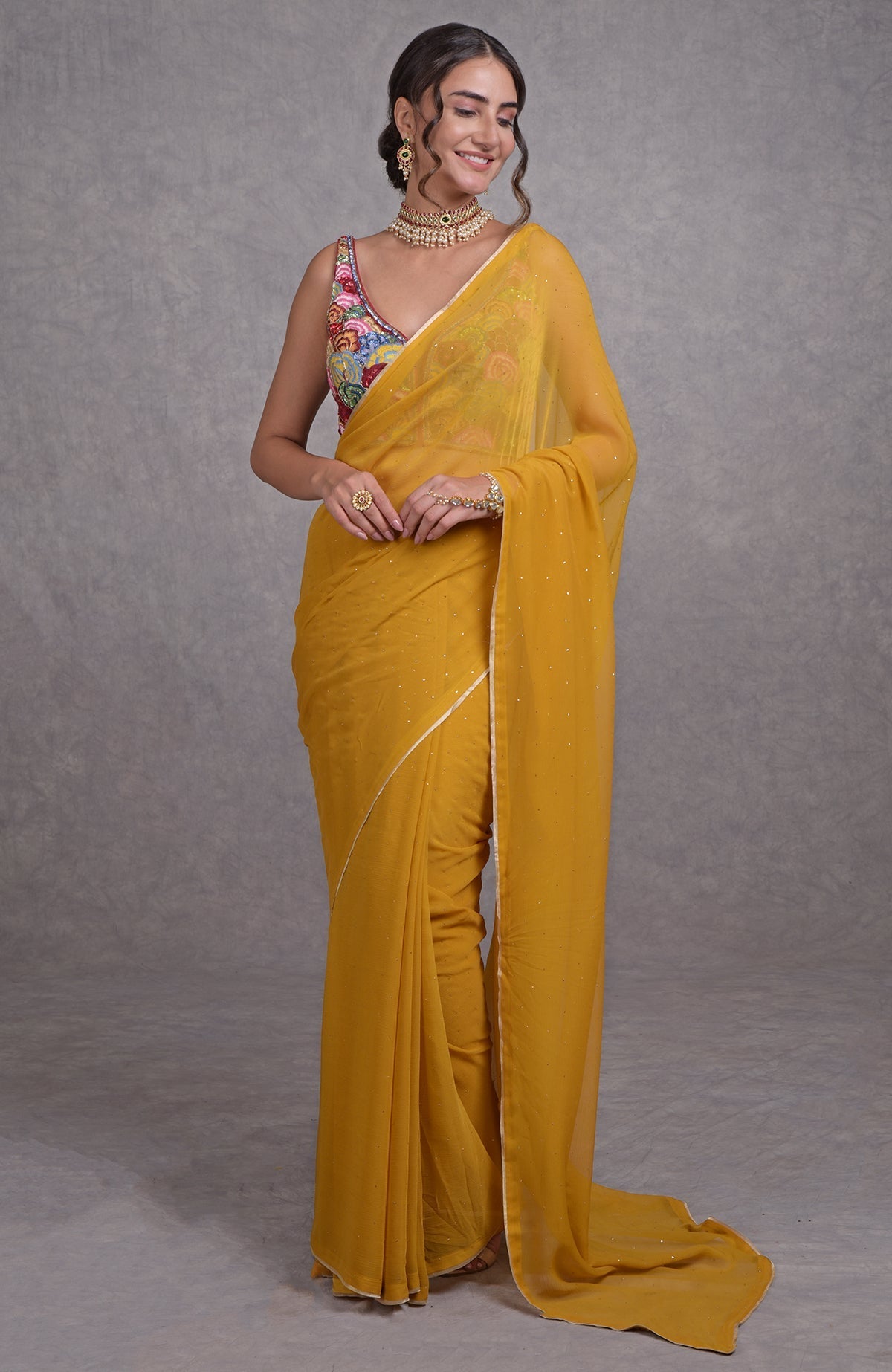 Mustard yellow saree with multicolor resham, dabka, sequin, bead, and Kamdani embroidery details.