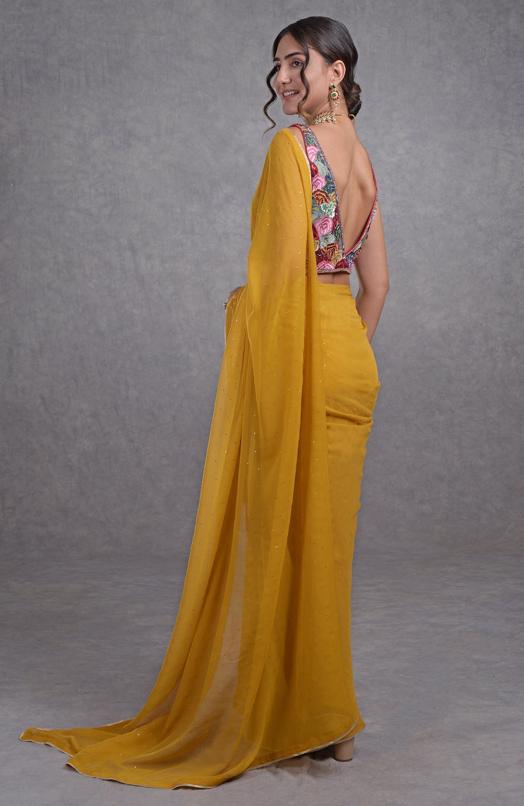 Mustard yellow saree with multicolor floral resham, dabka, sequin, bead, and Kamdani embroidery.
