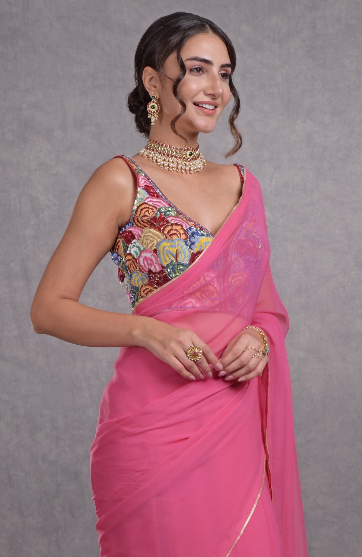 Hot pink saree with multicolor floral resham, dabka, sequin, and bead embroidery on blouse