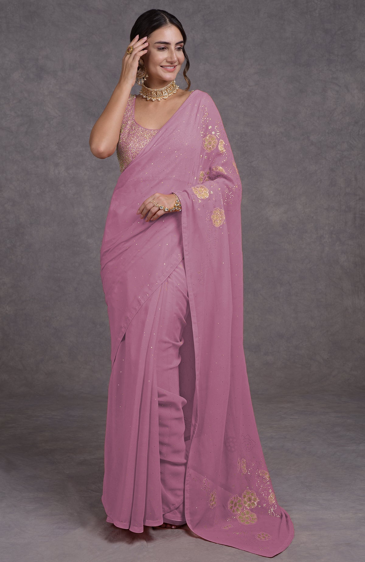 A woman models a pressed rose tissue cutwork hand embroidered mukaish saree.