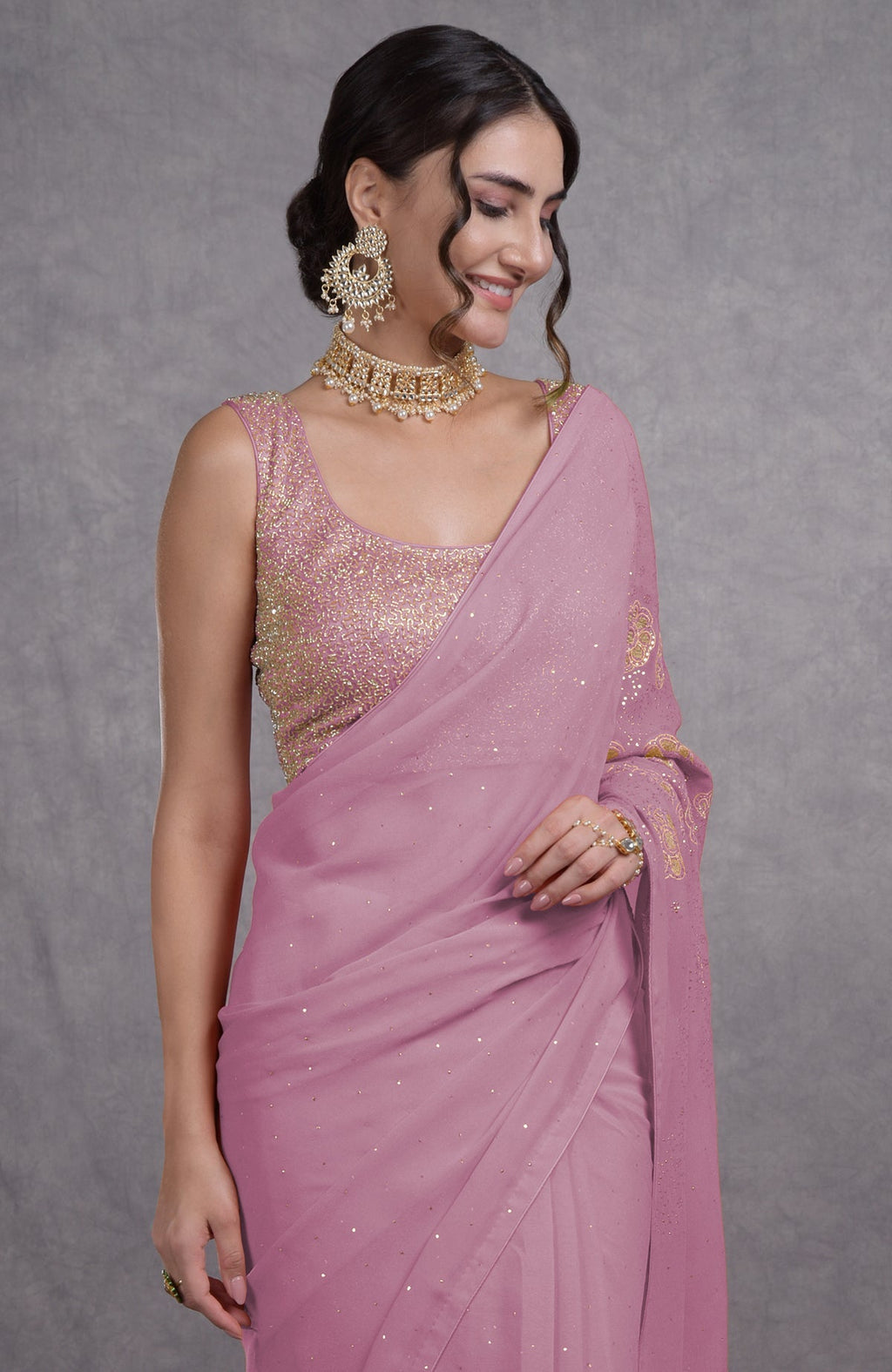 A woman models an orchid bouquet tissue cutwork hand embroidered mukaish saree.