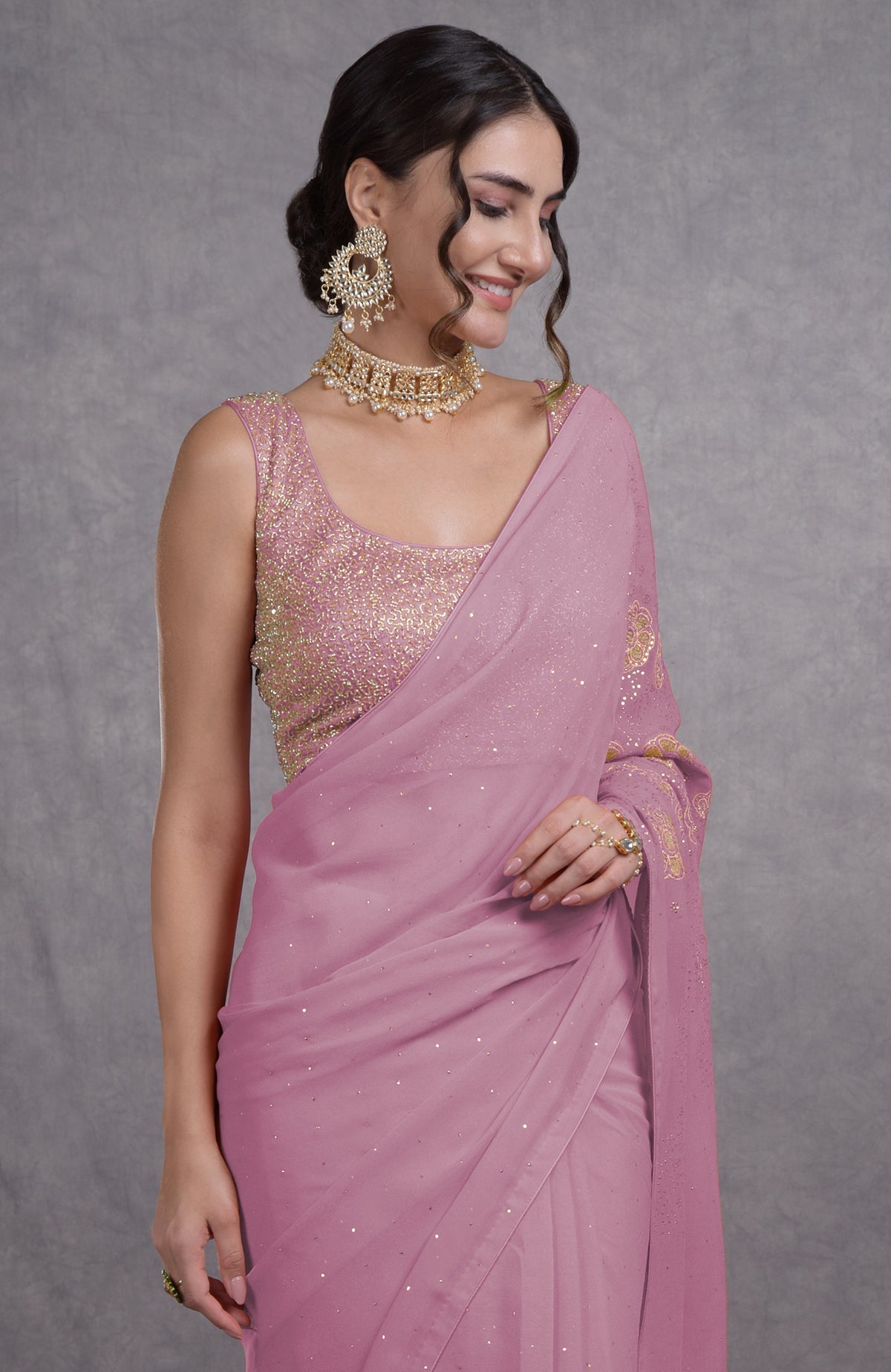 A woman models an orchid bouquet tissue cutwork hand embroidered mukaish saree.
