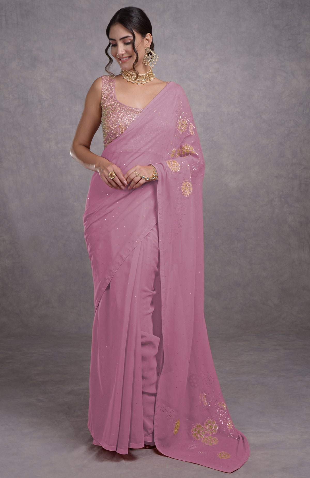 A woman models an orchid bouquet tissue cutwork hand embroidered mukaish saree.