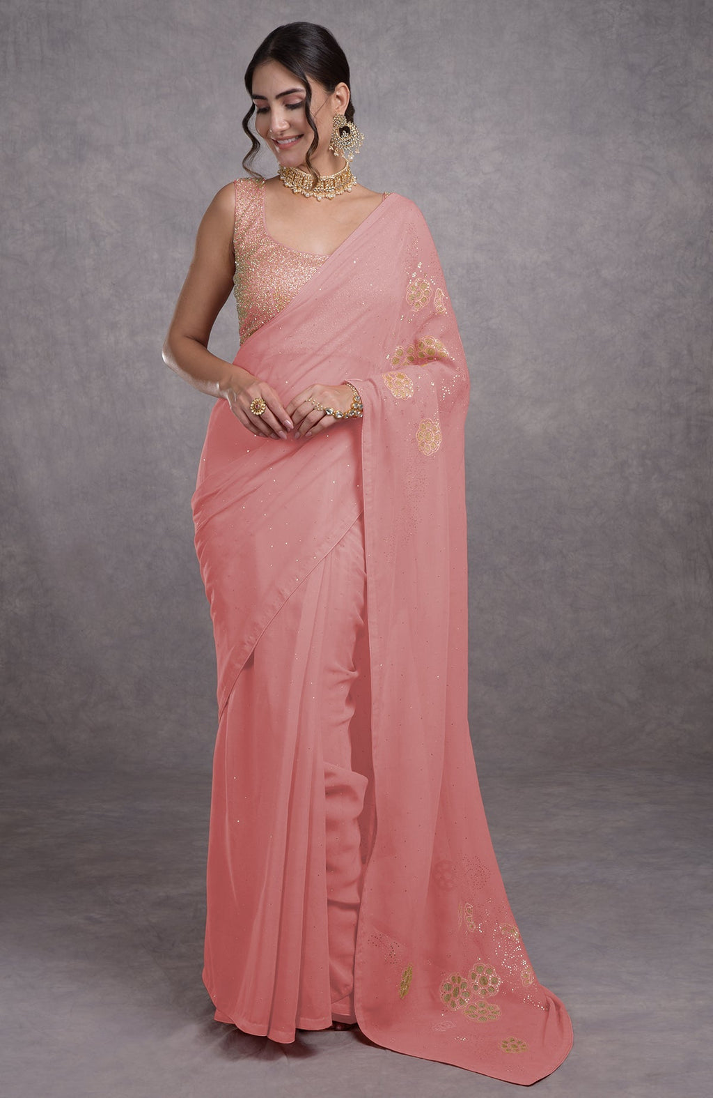 A woman models a pressed rose tissue cutwork hand-embroidered mukaish saree.