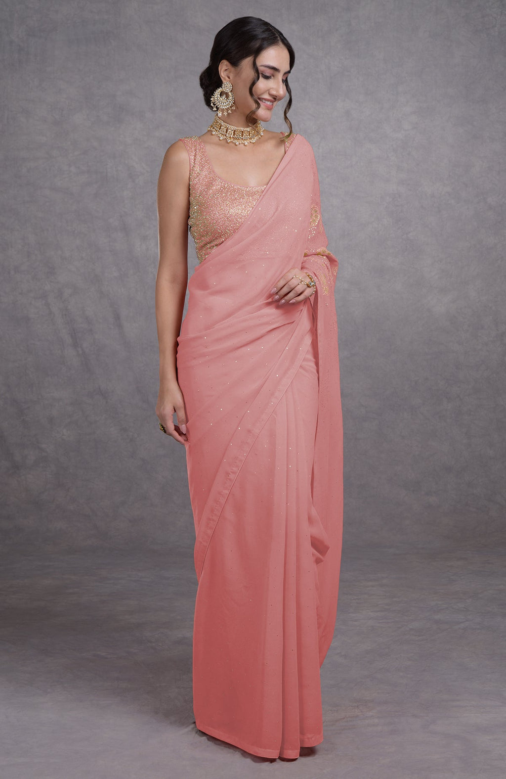 A woman models a pressed rose tissue cutwork hand-embroidered mukaish saree.
