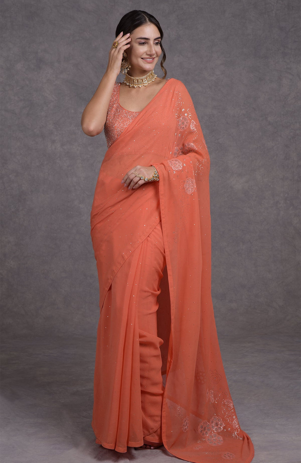 Peach camellia saree with hand-embroidered mukaish and tissue cutwork floral motifs on georgette fabric
