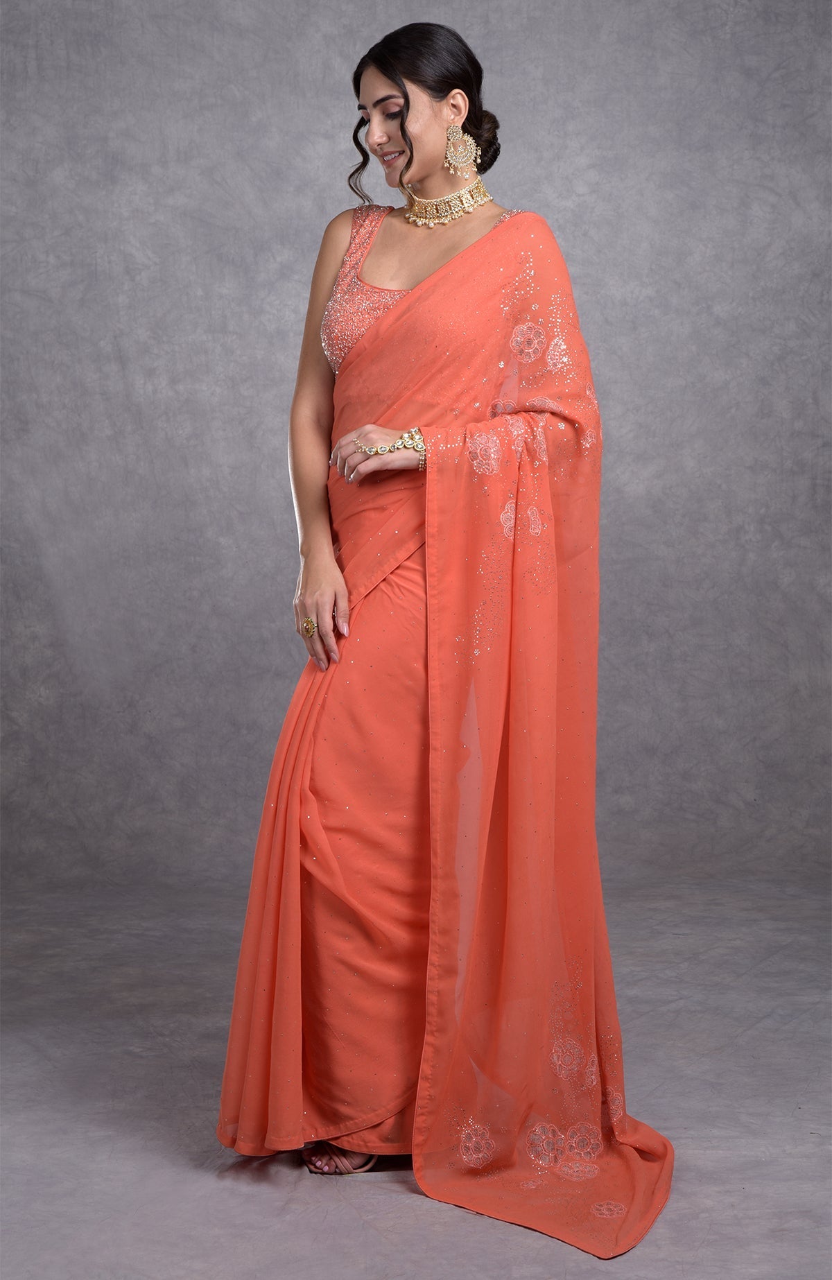 Peach camellia saree with hand-embroidered mukaish and tissue cutwork floral motifs
