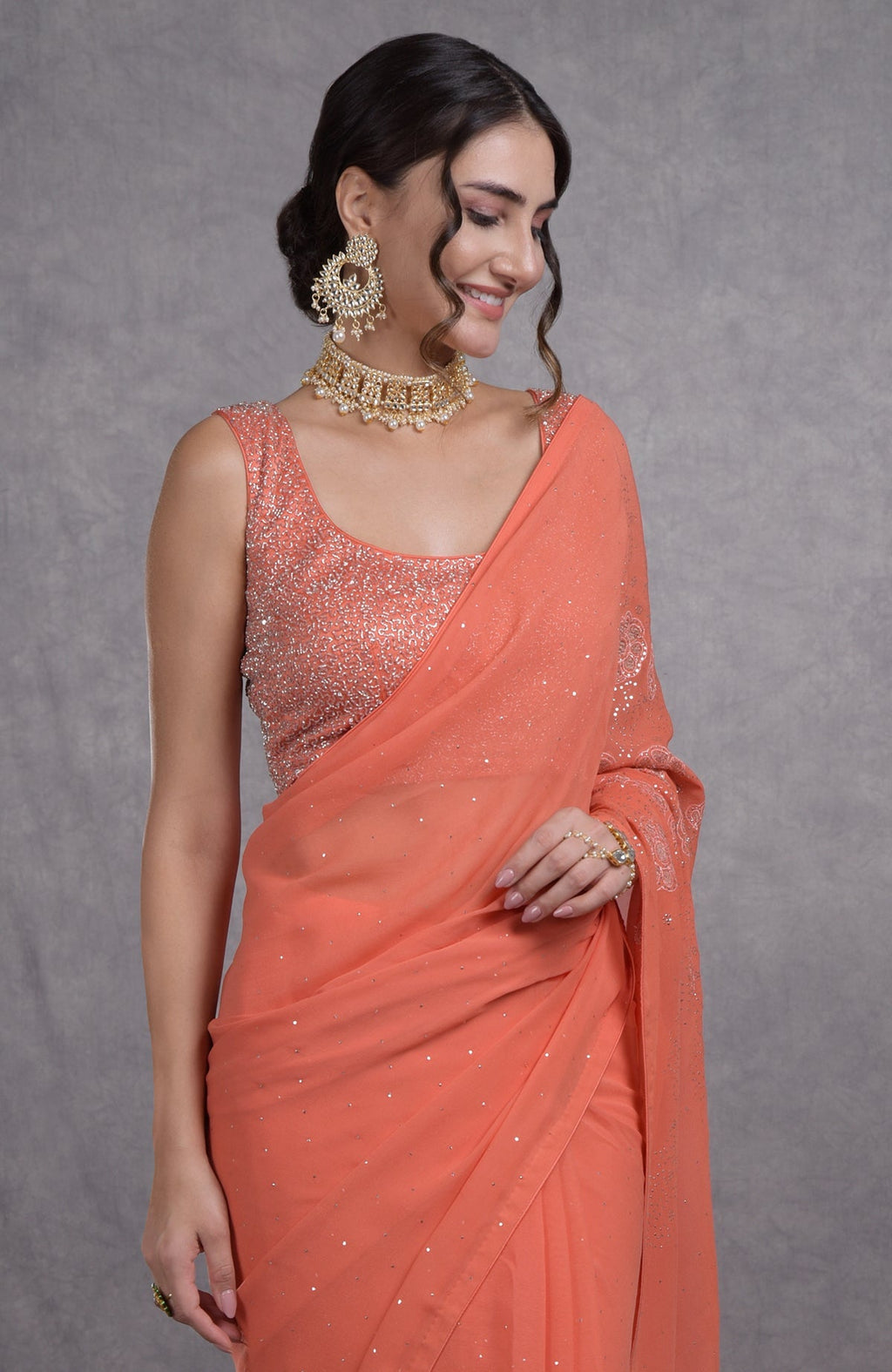 Peach camellia saree with hand-embroidered mukaish and tissue cutwork floral motifs