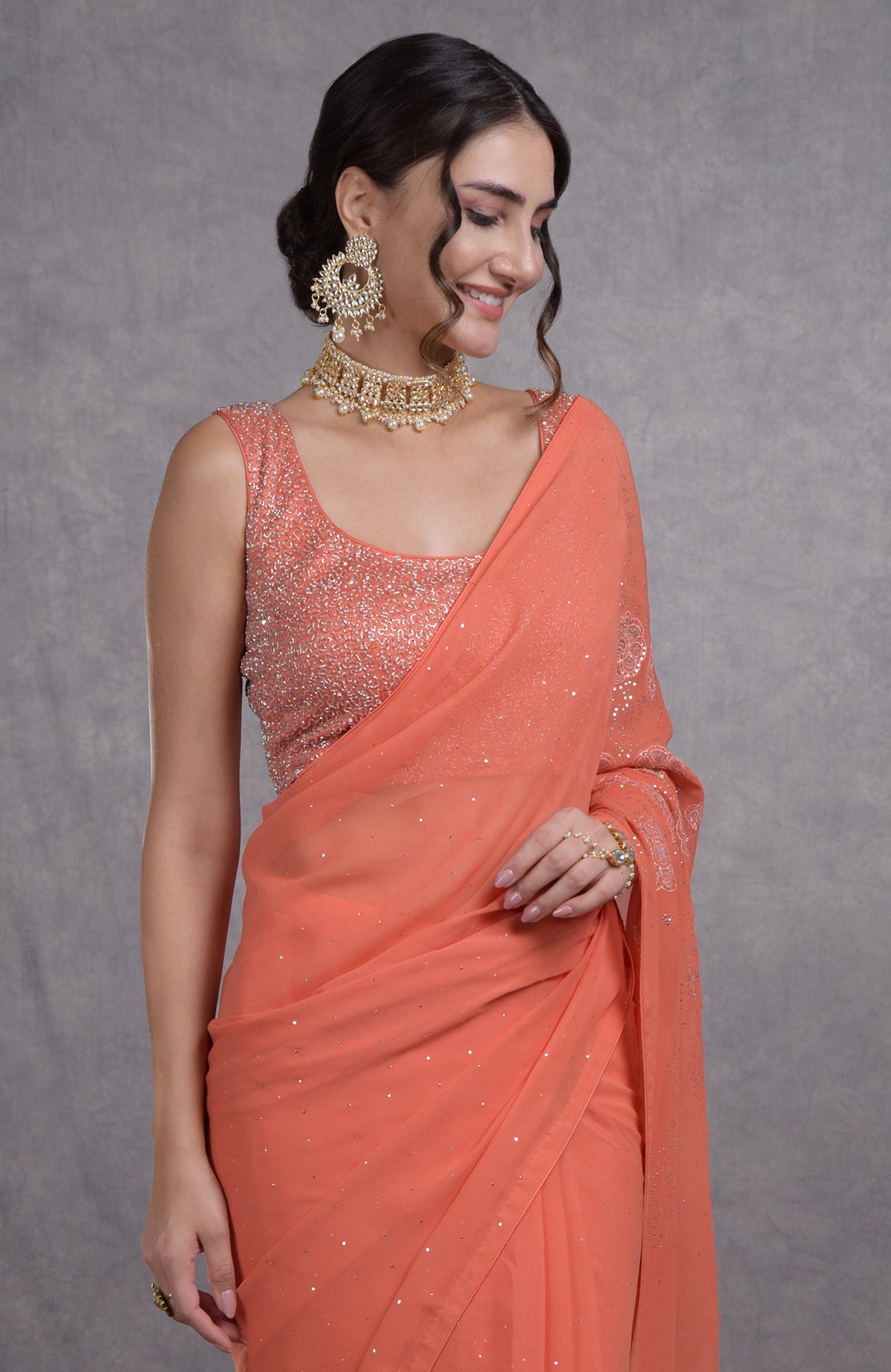 Peach camellia saree with hand-embroidered mukaish and tissue cutwork floral motifs