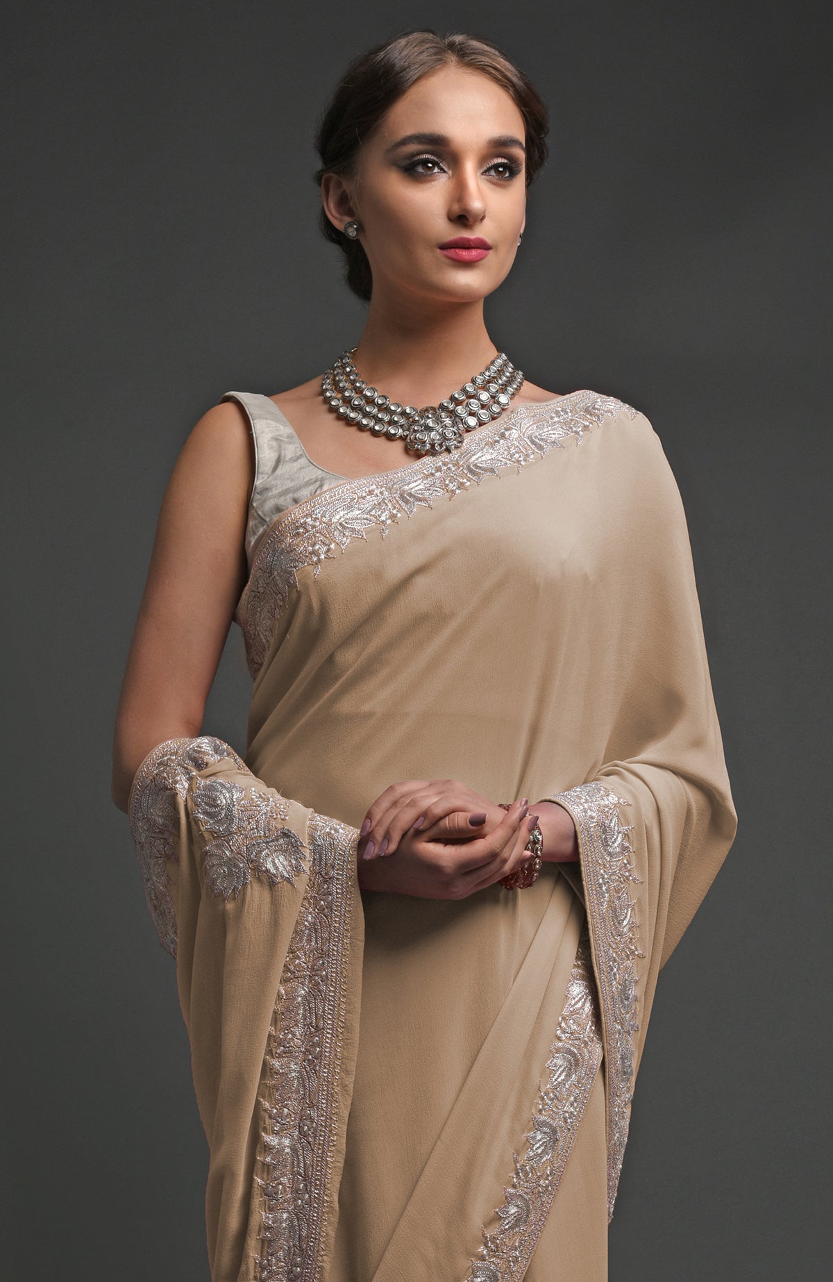 Beige georgette saree with silver Kashmiri tilla lotus embroidery on pallav and borders