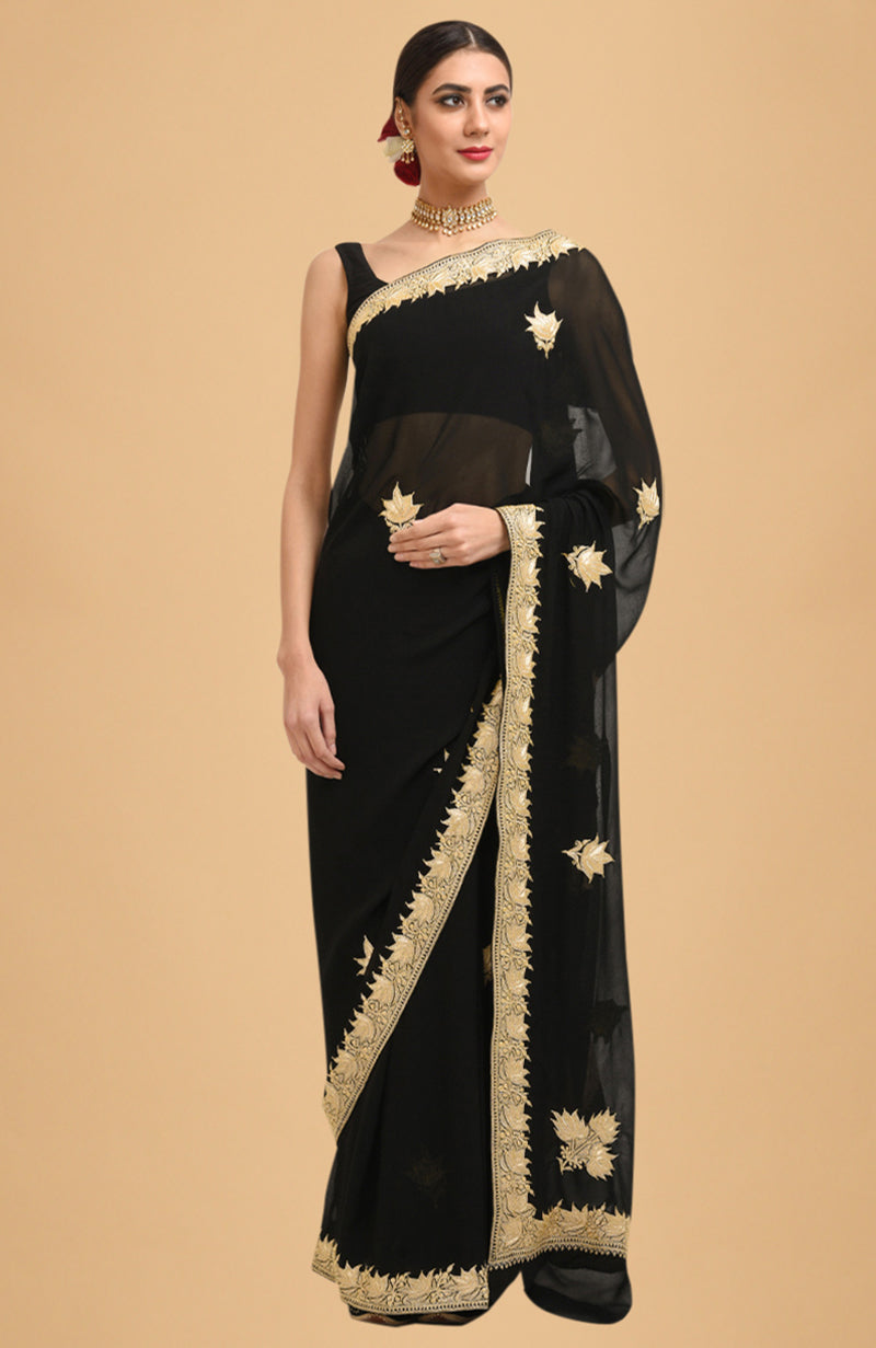 Black georgette saree with gold Kashmiri tilla lotus embroidery on pallav and borders.