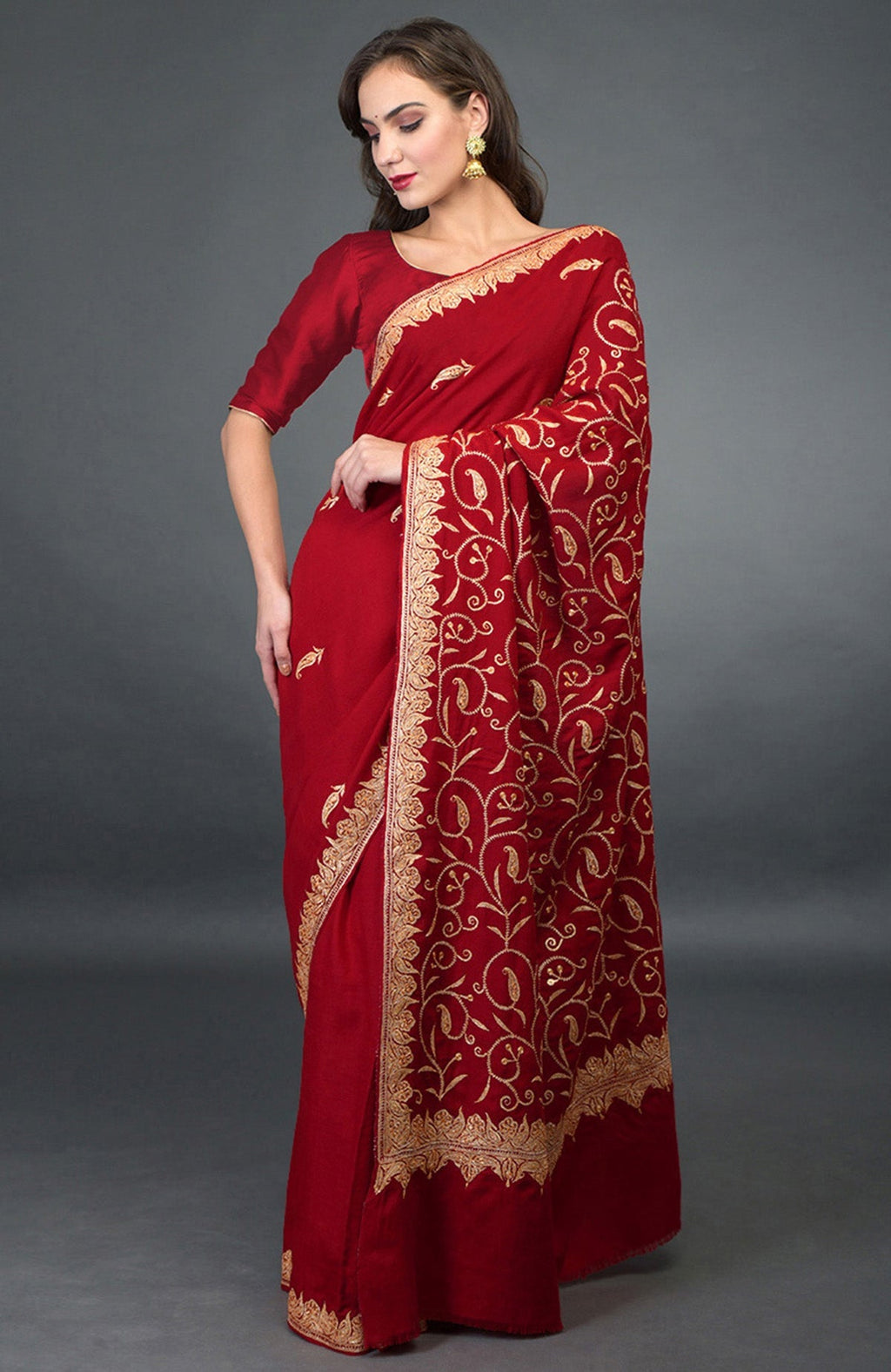 Red pure crepe saree with gold Kashmiri tilla embroidery and paisley bootis design.
